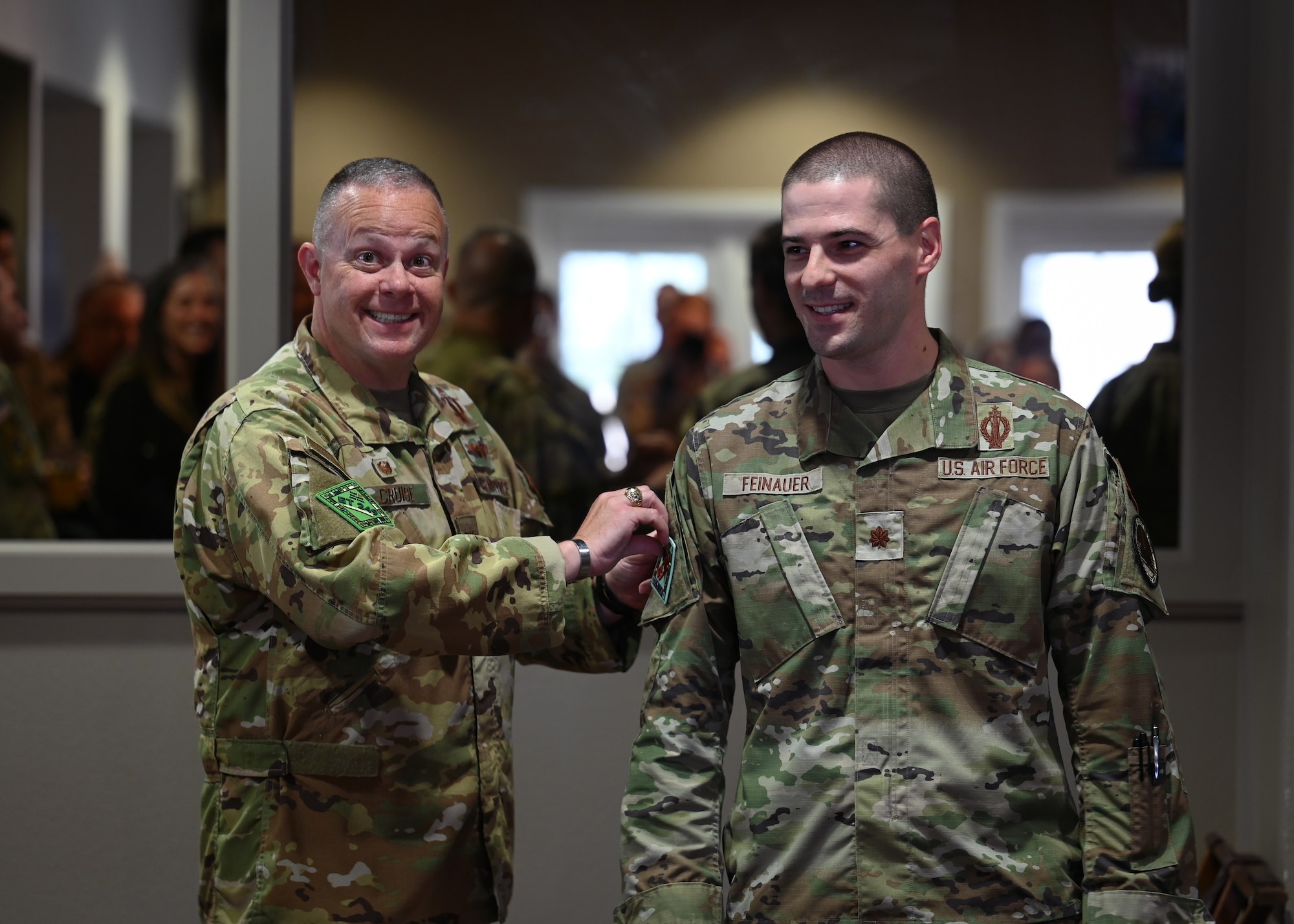 Two men pose for a group photo.