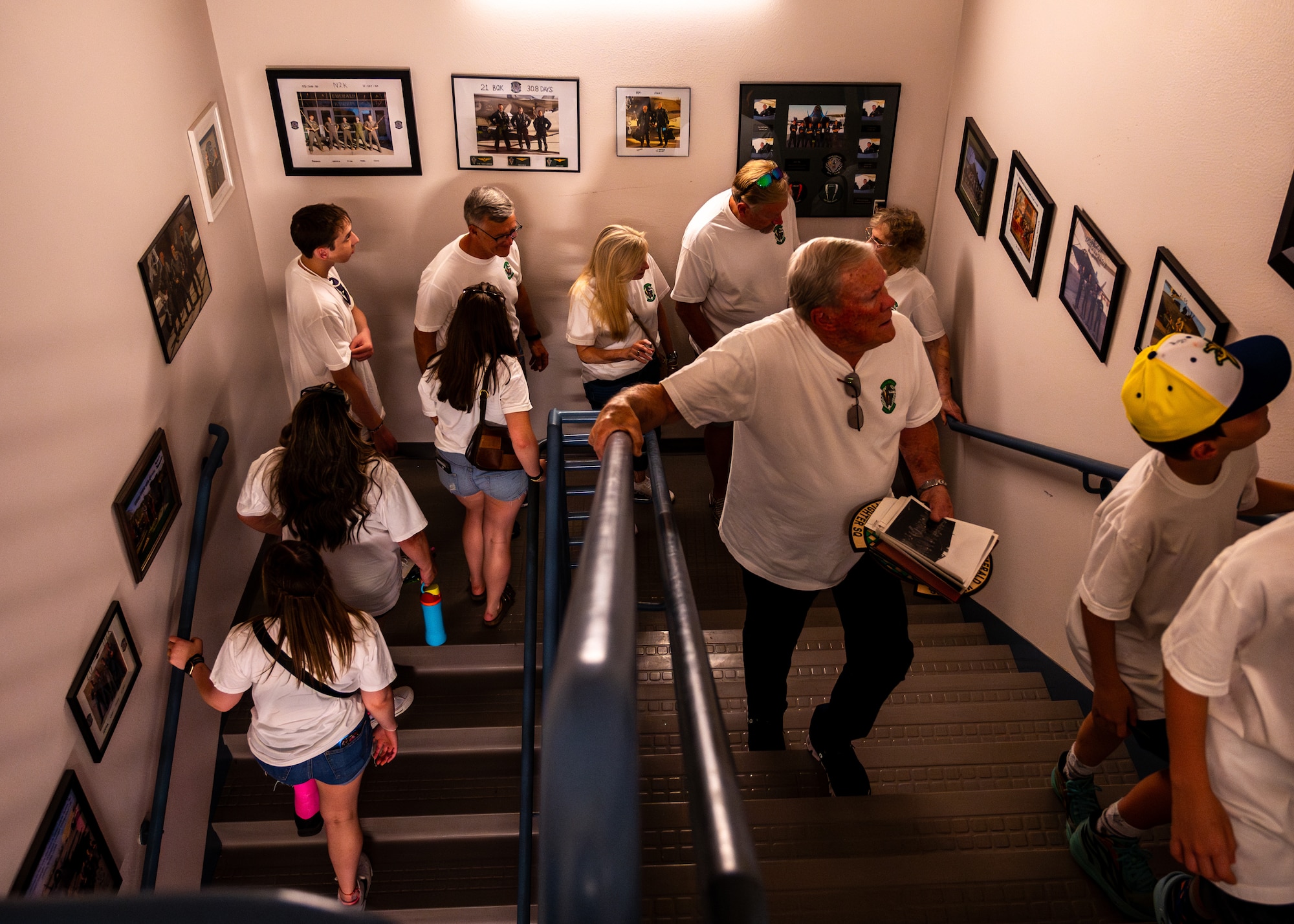 Retired U.S. Air Force Lt. Col. David Kling (center right), views historical photos of the 308th Fighter Squadron with his family during a heritage tour, March. 31, 2024 at Luke Air Force Base, Arizona.