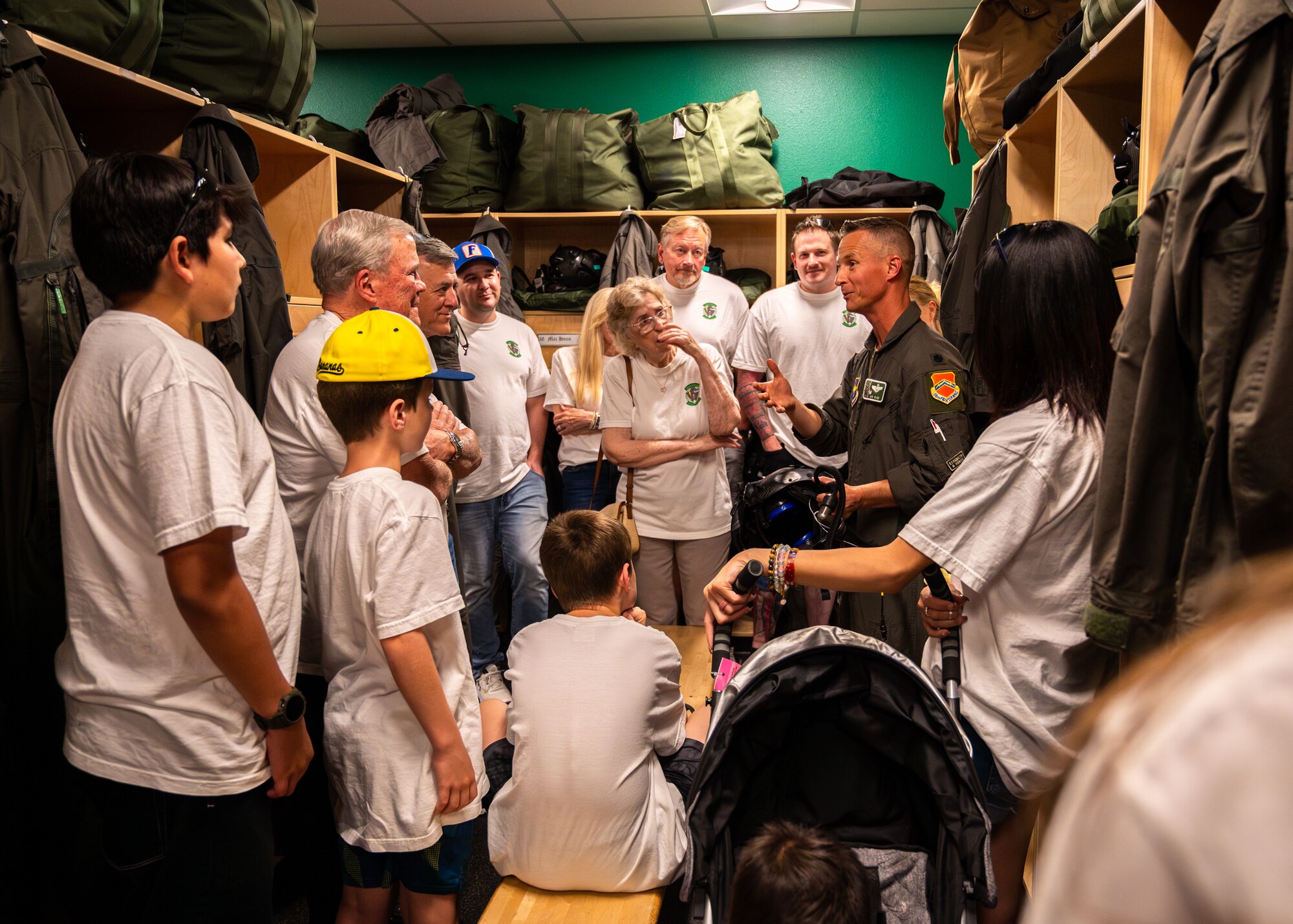 U.S. Air Force Lt. Col. Brett Black (right), 308th Fighter Squadron commander, shows the 308th FS pilot locker room to retired Lt. Col. David Kling (left) and his family during a heritage tour, March. 31, 2024 at Luke Air Force Base, Arizona.