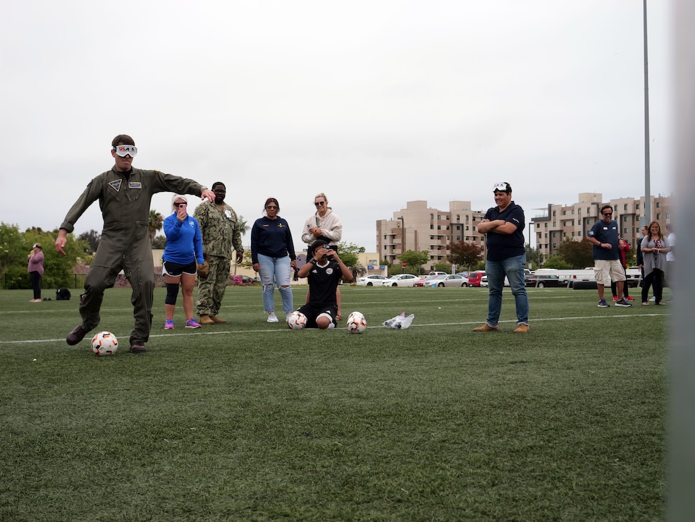 U.S. Navy Capt. Loren Jacobi, executive officer of Naval base Coronado, attempts a penalty kick during an U.S. Association of Blind Athletes demonstration on the installation. Navy Region Southwest's Wounded Warrior program organized the visit for USABA athletes and service members can interact with each other.
