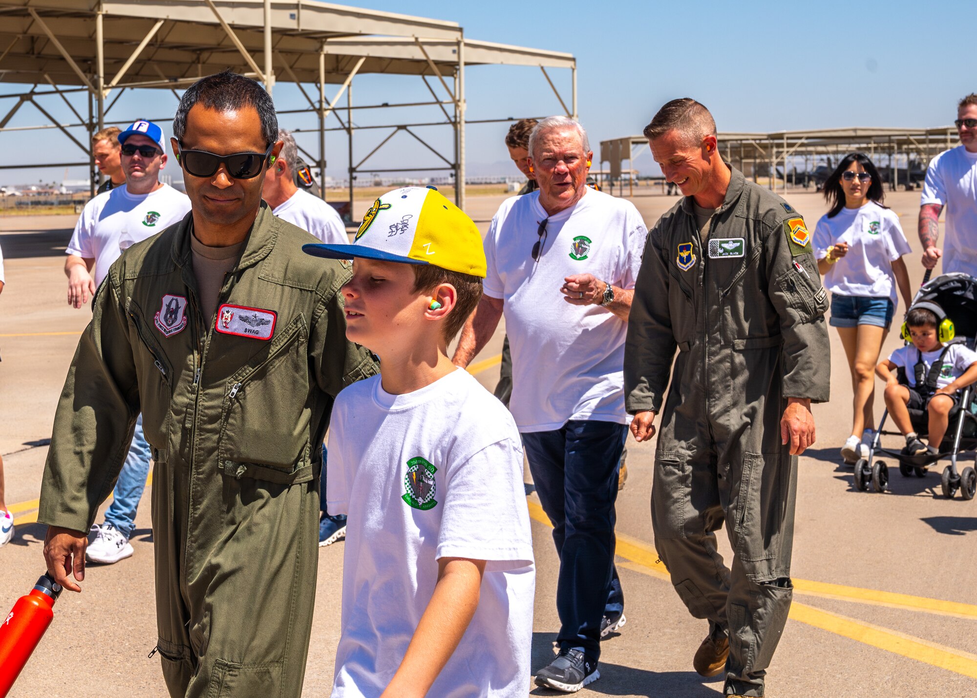 Retired U.S. Air Force Lt. Col. David Kling (center left), speaks with U.S. Air Force Lt. Col. Brett Black (center right), 308th Fighter Squadron commander, on the flight line during a heritage tour, March. 31, 2024 at Luke Air Force Base, Arizona.