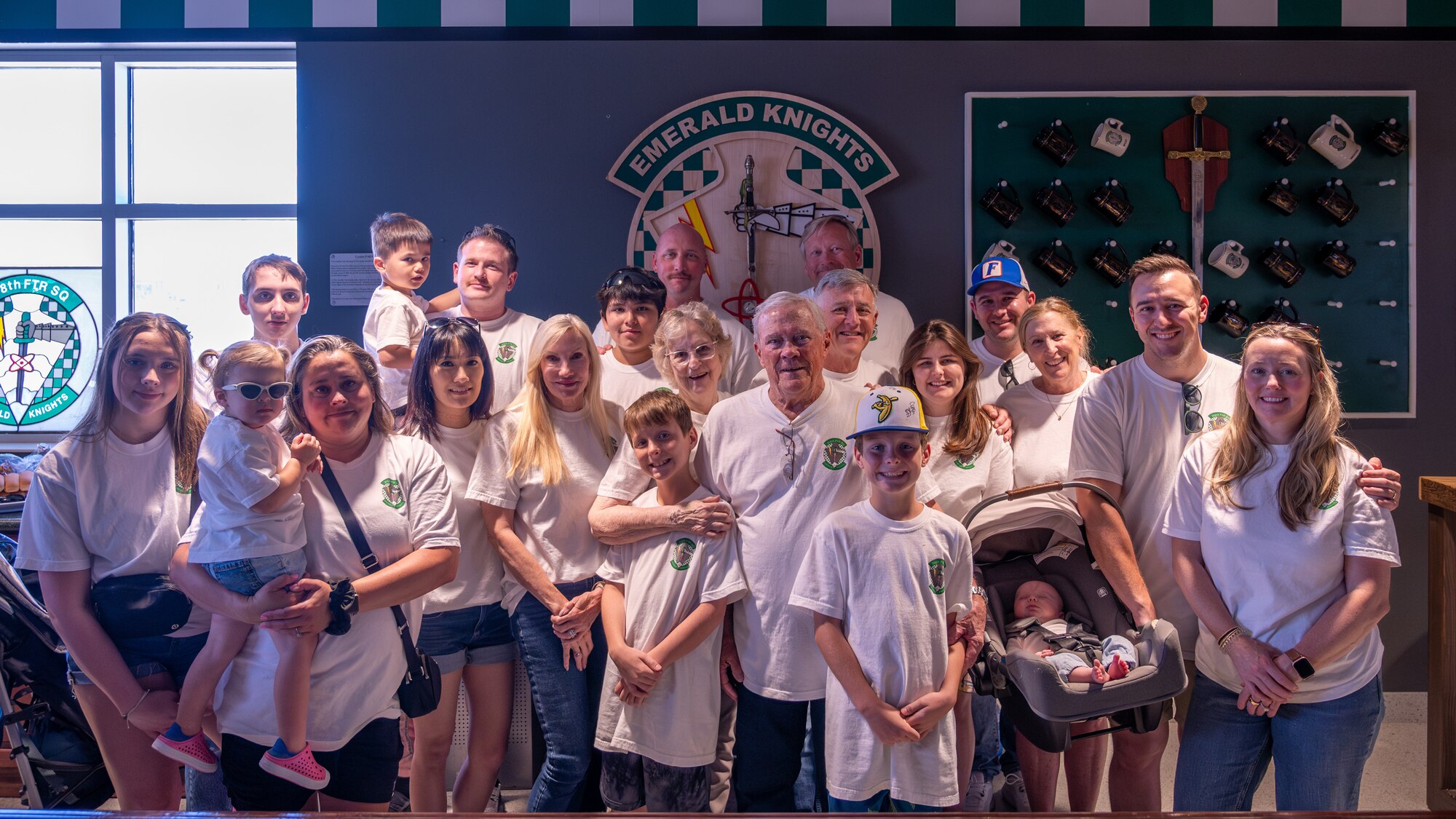 Retired U.S. Air Force Lt. Col. David Kling (center right), poses in front of a 308th Fighter Squadron plaque with his family during a heritage tour, March. 31, 2024 at Luke Air Force Base, Arizona.