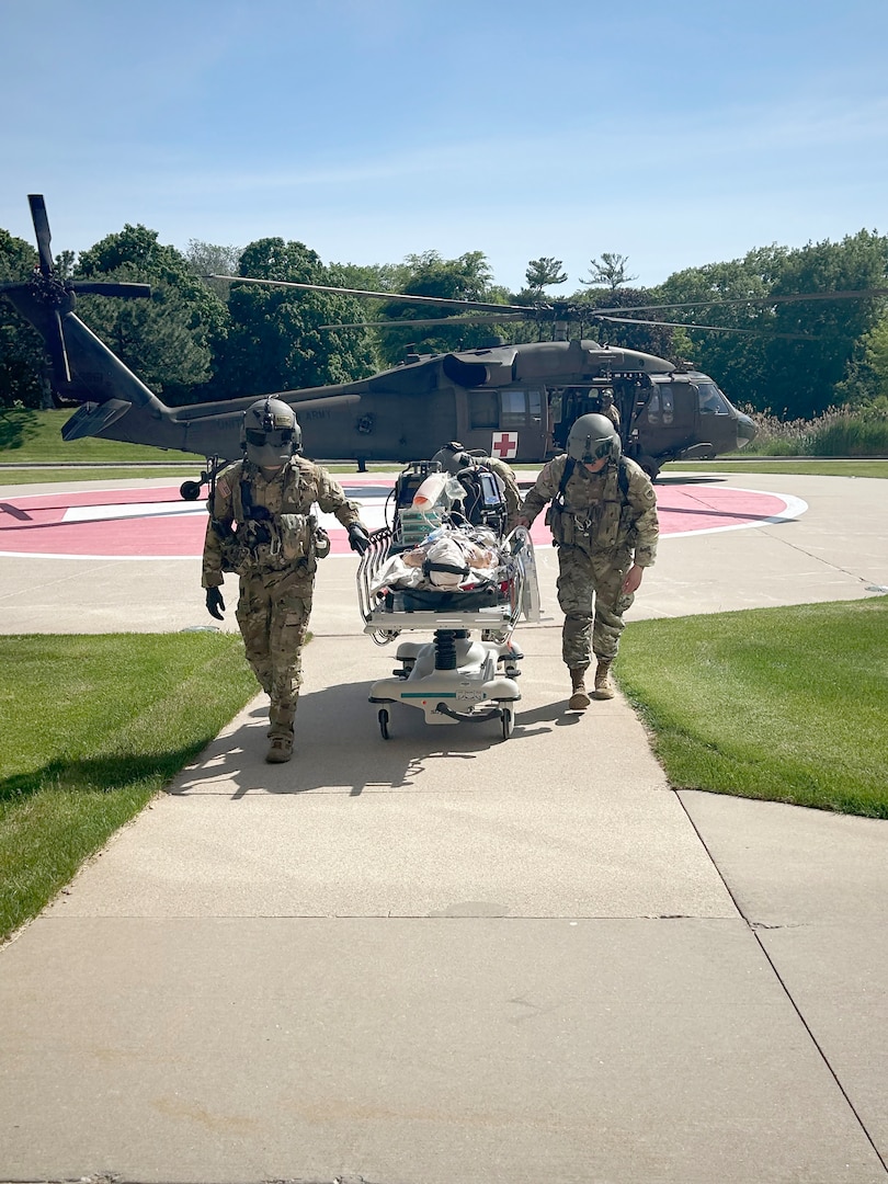 West Bend, Wis.-based Black Hawk helicopter crews from the Wisconsin Army National Guard’s 1st Battalion, 147th Aviation Regiment deliver a simulated patient to Aurora BayCare in Green Bay, Wis., as part of a mock mass casualty exercise May 31. The scenario called for a single Black Hawk crew to medically evacuate three victims critically injured by a building collapse to Aurora Medical Center-Summit. A Black Hawk can transport up to four litter-borne patients, as opposed to civilian air ambulances which carry only one patient. The training called for one patient to be transported from Summit to Green Bay for additional care. This training builds on prior collaboration between the Wisconsin Army National Guard and Aurora Health Care. Aurora Health Care photo