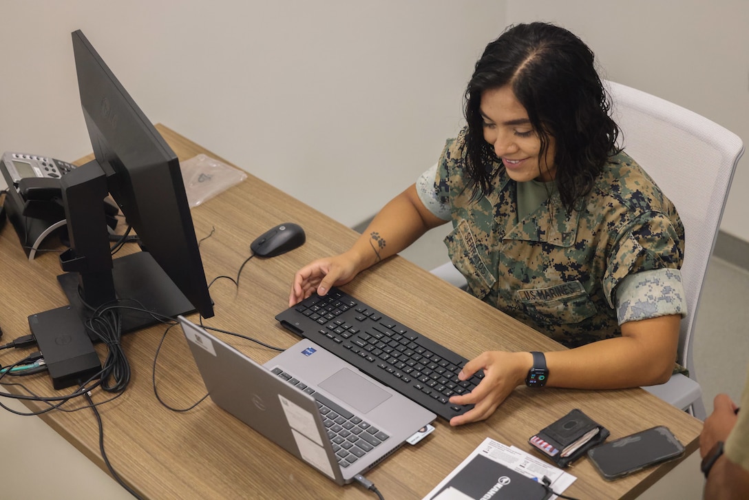 U.S. Marine Corps Lance Cpl. Maria Serratos, data systems administrator for Marine Corps Base Camp Blaz, reimages a computer at the Marine Corps Ground Support Element building on Andersen Air Force Base, Guam, June 12, 2023. The data system Marines have been facilitating the distribution of assets to support Camp Blaz staff post typhoon Mawar. A dual-status command, comprising both Title 10 forces from U.S. Army Pacific's Task Force West and Title 32 Guam National Guard Forces in support of the Governor of Guam, are the DoD entities unified in their support to the civil authorities and the people of Guam and the Marianas during Typhoon Mawar response recovery. (U.S. Marine Corps photo by Lance Cpl. Garrett Gillespie)