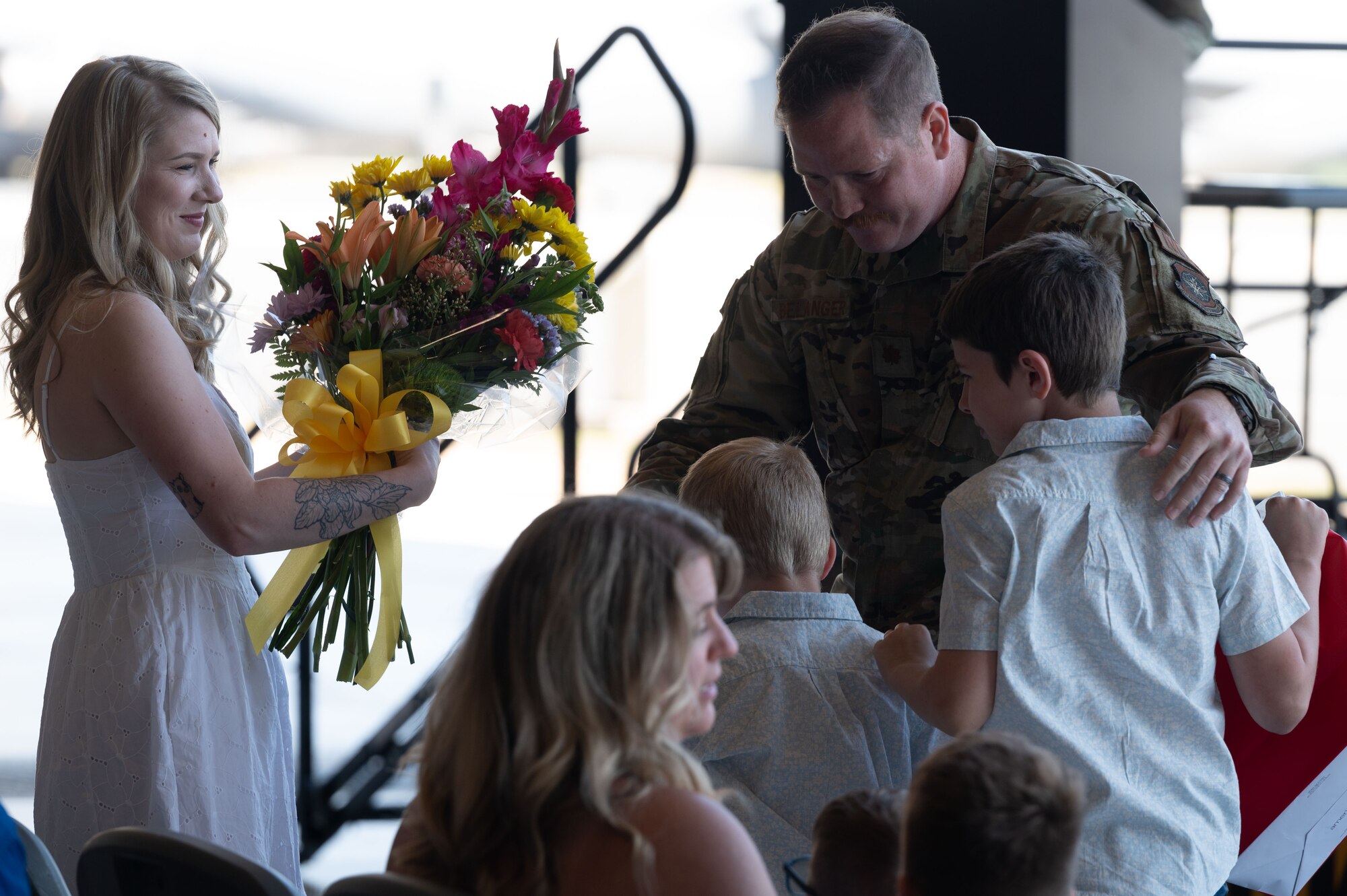 U.S. Air Force Maj. Joshua Belanger, incoming 436th Maintenance Squadron commander, embraces his family during a change of command ceremony at Dover Air Force Base, Delaware, June 10, 2024. The ceremony saw Lt. Col. Alexander Barnett relinquish command to Belanger. (U.S. Air Force photo by Dieondiere Jefferies)