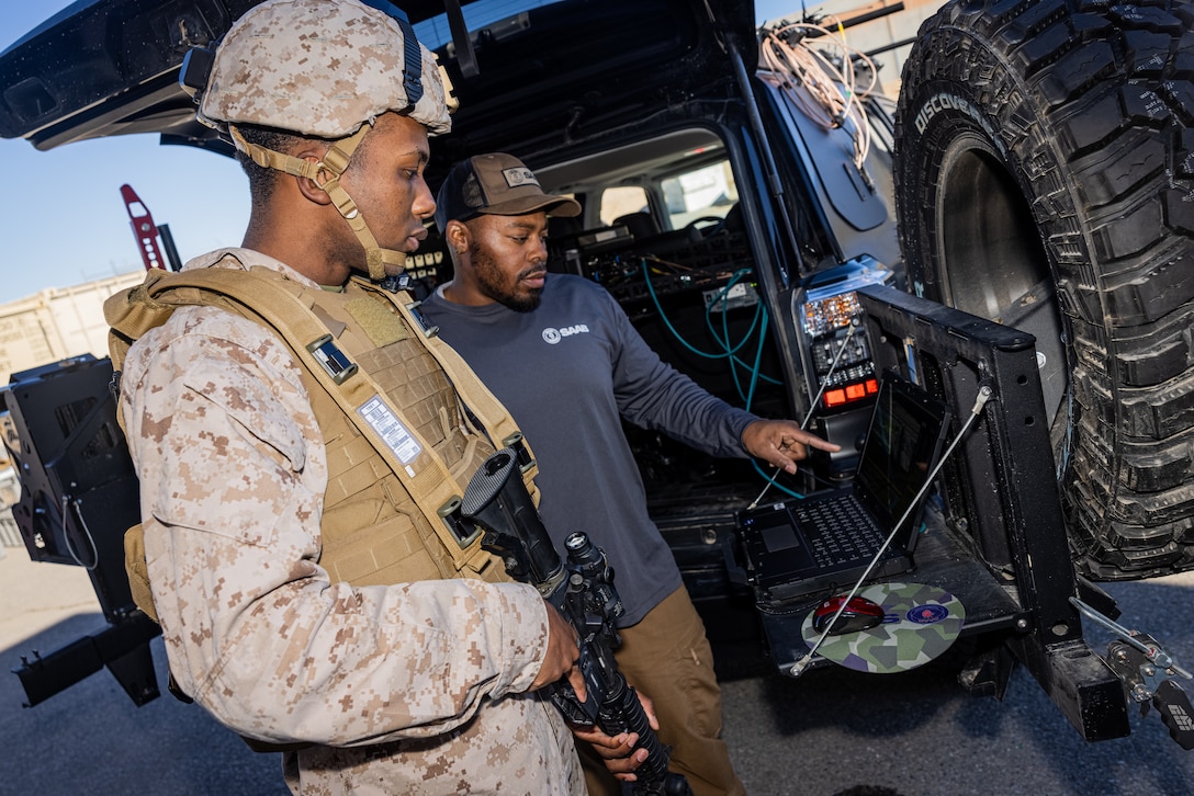 U.S. Marine Corps Nyron Lewis, combat photographer, Marine Corps Air-Ground Combat Center, Marine Air-Ground Task Force Training Command, uses the Joint Terminal Attack Controller Virtual Trainer during a gear demonstration at MCAGCC, Twentynine Palms, California, Dec. 28, 2023. The JTACVT is a Deployable Tactical Air Control Party Training and Readiness Evaluation System that enables Marines to conduct accurate training for Marine fire support teams by enabling evaluations and training to be held anywhere. (U.S. Marine Corps photo by Cpl. Jonathan Willcox)