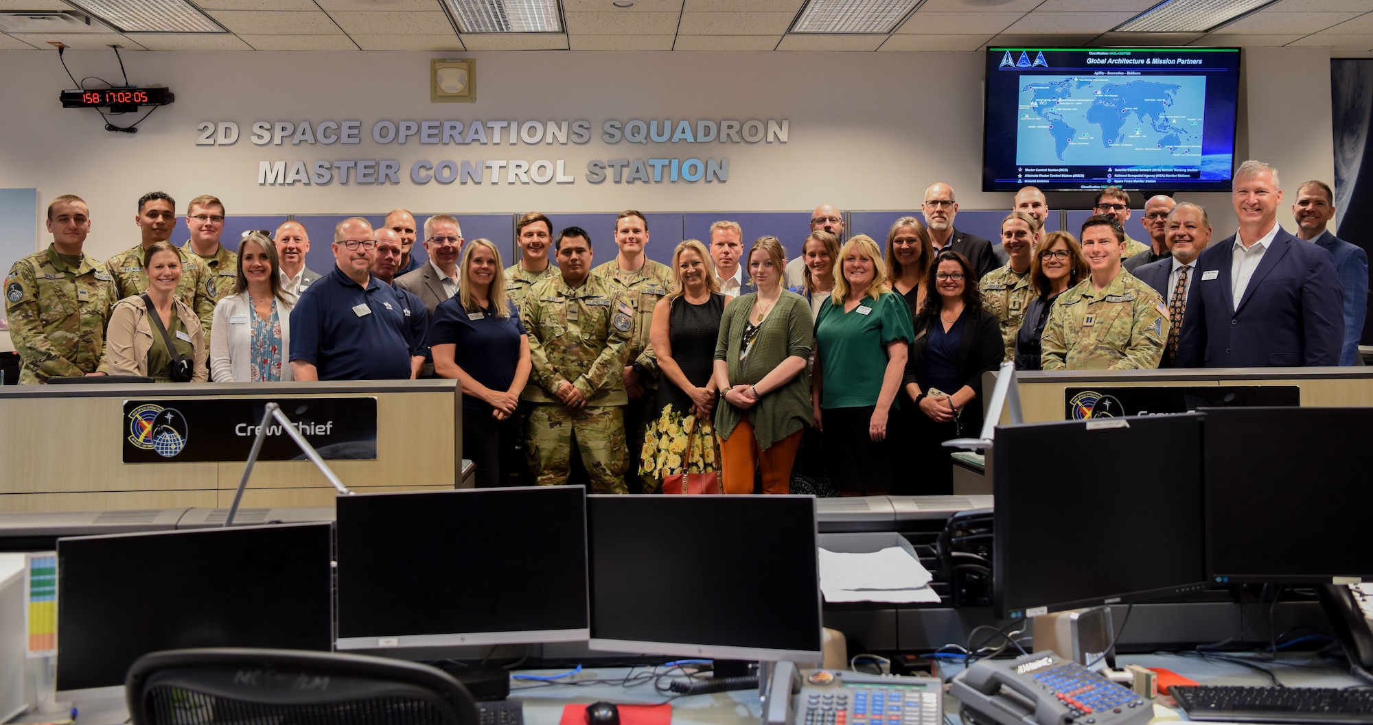 Members and partners of the Military Affairs Council, Colorado Springs Chamber and EDC gather for a group photo on the 2nd Space Operations Squadron operations floor at Schriever Space Force Base, Colorado, June 6, 2024. The CO Springs MAC, through relationships with installations, government and business leaders, lift the voice of military missions, members, families and veterans. (U.S. Space Force photo by 1st Lt. Danielle Rose)