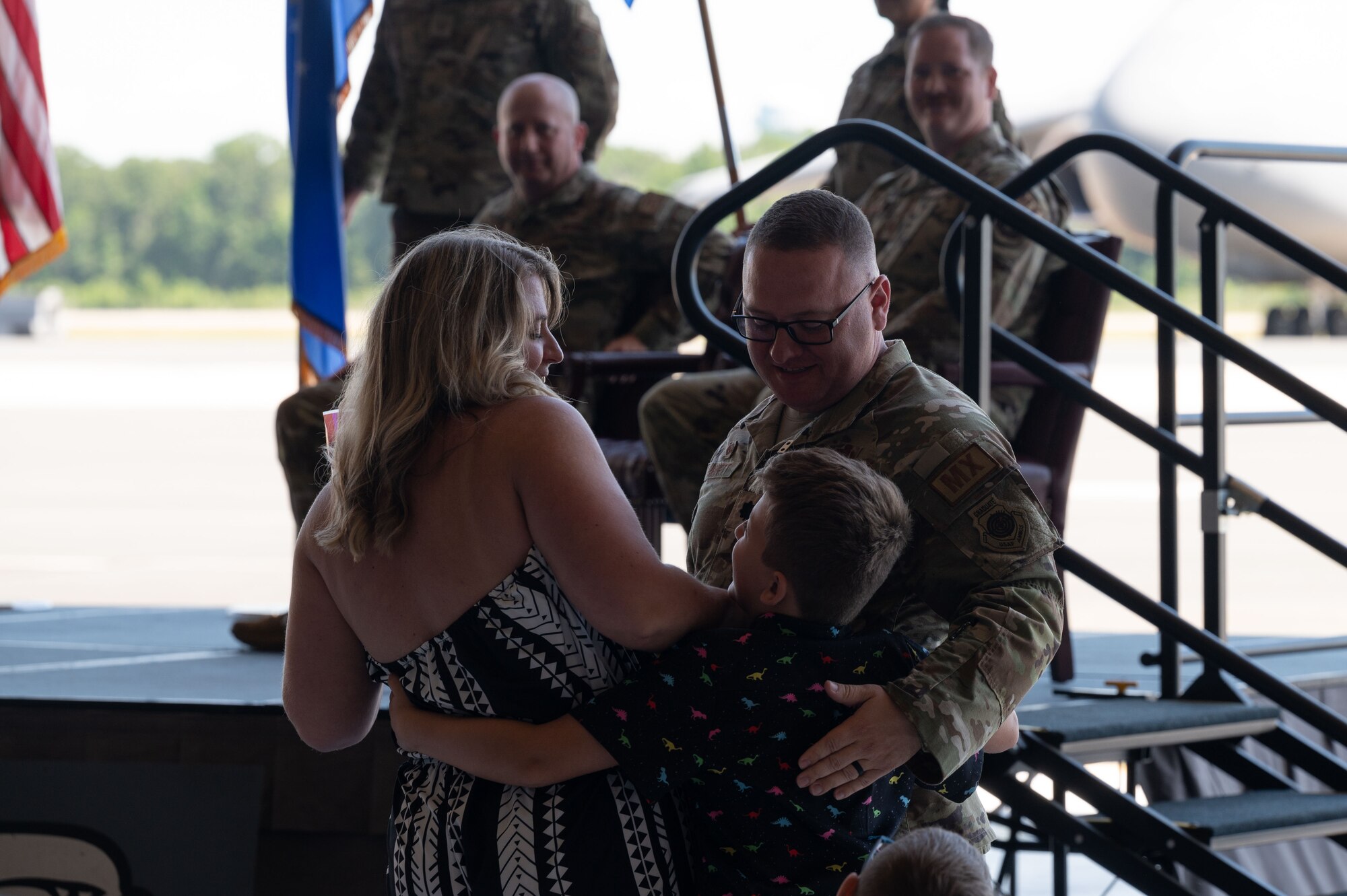 U.S. Air Force Lt. Col. Alexander Barnett, outgoing 436th Maintenance Squadron commander, embraces his family during a change of command ceremony at Dover Air Force Base, Delaware, June 10, 2024. The ceremony saw Barnett relinquish command to Maj. Joshua Belanger. (U.S. Air Force photo by Dieondiere Jefferies)