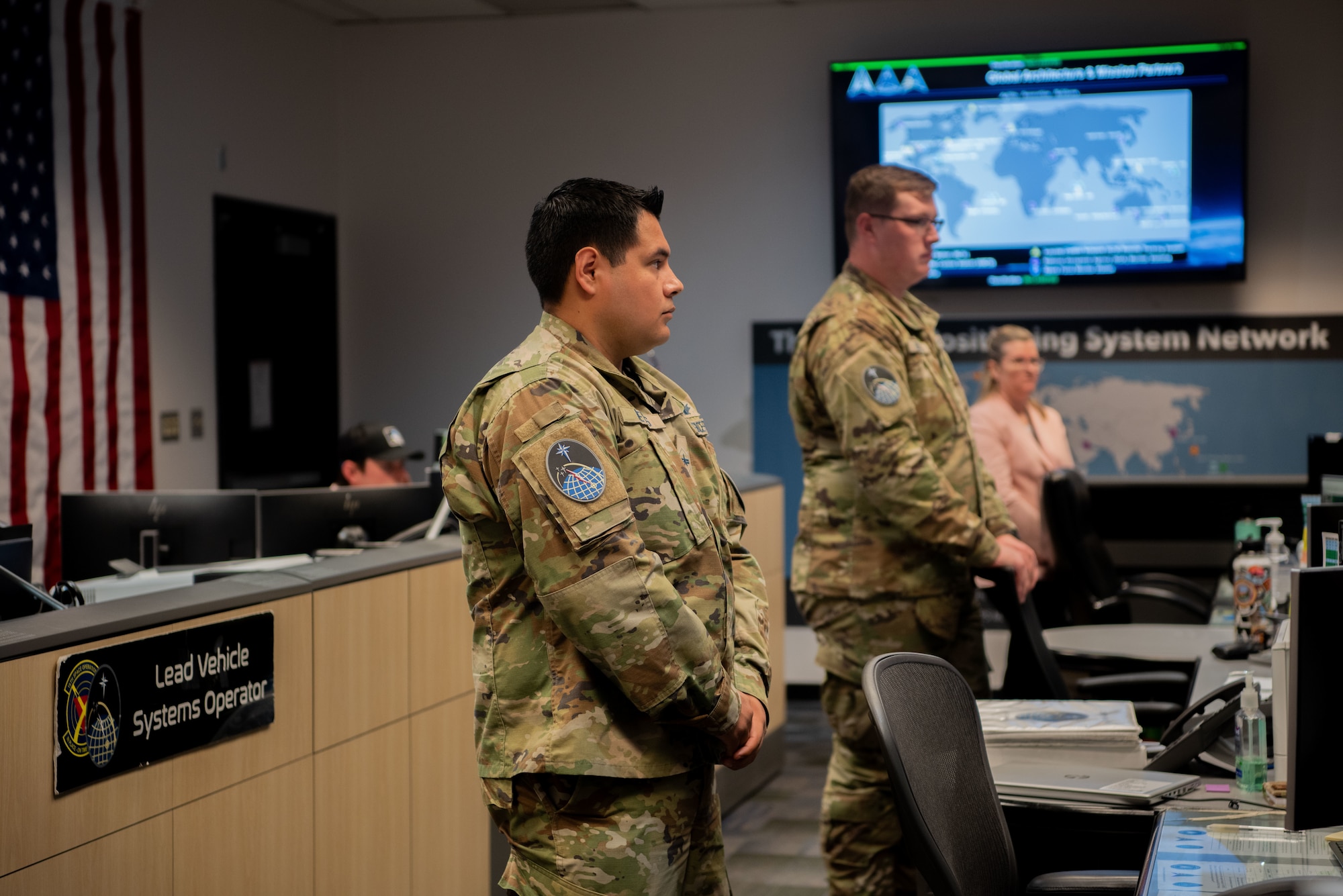2nd Space Operations Squadron Guardians listen as Lt. Col. Robert Wray, 2 SOPS commander, briefs members and partners of the Military Affairs Council, Colorado Springs Chamber and EDC at Schriever Space Force Base, Colorado, June 6, 2024. 2 SOPS Guardians provide America and its allies precise position, navigation and timing information to military and civilian users around the globe through NAVSTAR GPS, the military's largest and the world's most widely-used satellite constellation. (U.S. Space Force photo by 1st Lt. Danielle Rose)