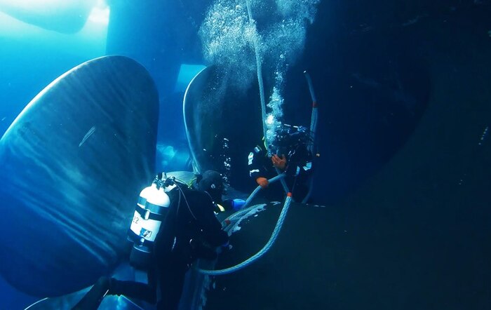 Two Coast Guard divers beneath the Coast Guard Cutter Polar Star in Antartica. (U.S. Coast Guard photo)