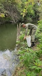 A Navy graduate of the METC Preventive Medicine Technician course participates in the Entomology block of the U.S. Army Medical Center of Excellence Preventive Medicine Operations course by conducting mosquito larvae surveillance at Salado Creek at Joint Base San Antonio-Fort Sam Houston.