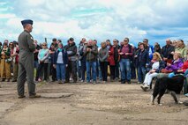 U.S. Air Force Lt. Col. Brad Fisher, commander of the 15th Airlift Squadron, delivers remarks to a gathered crowd during the ceremony at the RAF Ramsbury Community Fair, honoring the 80th anniversary of D-Day, June 8, 2024, in Ramsbury, U.K. Members of the local community and visitors listened attentively as Fisher recounted the courageous efforts of the 437th Troop Carrier Group, detailing their critical role in the airborne operations of D-Day and their significant contributions throughout World War II. (U.S. Air Force photo by 1st Lt. Taylor Ferry)