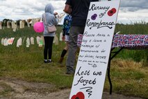 A sign at the RAF Ramsbury Community Fair encourages visitors to take a tag and leave a message of remembrance for fallen heroes, June 8, 2024, in Ramsbury, U.K. The "Runway of Remembrance" was part of the fair's activities commemorating the 80th anniversary of D-Day, allowing attendees to honor and remember those who sacrificed their lives during World War II. (U.S. Air Force photo by 1st Lt. Taylor Ferry)