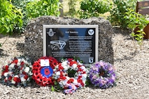 The memorial dedicated to the 437th Troop Carrier Group at RAF Ramsbury, adorned with wreaths laid during the RAF Ramsbury Community Fair, June 8, 2024, in Ramsbury, U.K. The memorial honors the units based at RAF Ramsbury from 1942 to 1946 and their significant contributions during D-Day and throughout World War II. (U.S. Air Force photo by 1st Lt. Taylor Ferry)