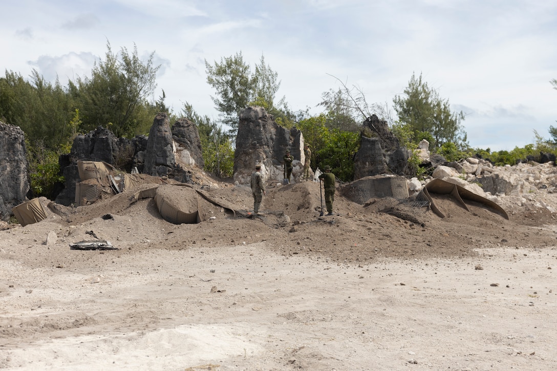 U.S. Marine Corps, Australian Army, and Canadian Army service members overlook a detonation area of a demolition site during Operation Render Safe Nauru at Yaren, Nauru, May 30, 2024.