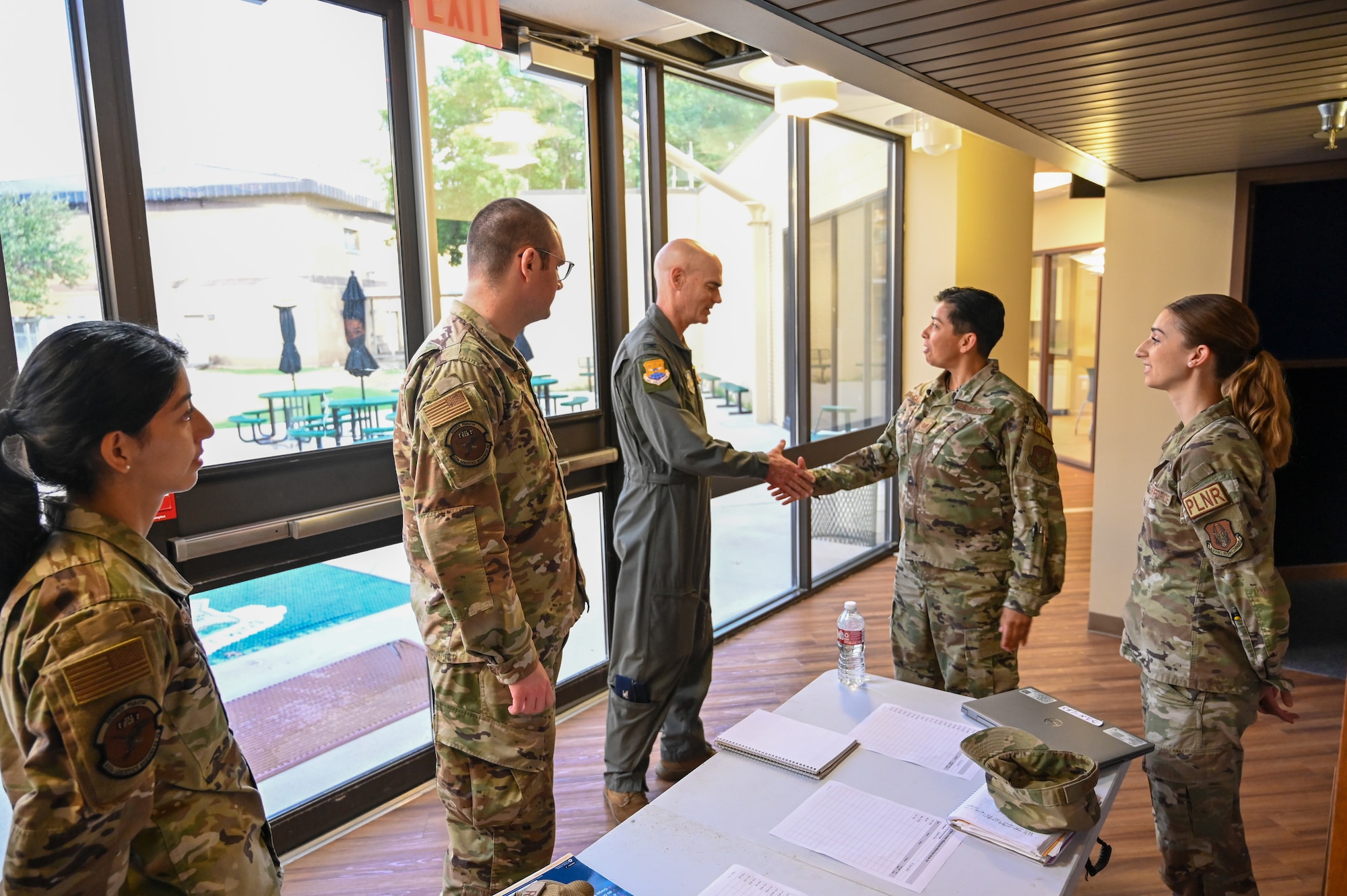 Col. William Gutermuth, 433rd Airlift Wing commander, shakes hands with members from the 433rd Logistics Readiness Squadron during a tour to varying 433rd AW units to say farewell on his final Unit Training Assembly drill weekend here at Joint Base San Antonio-Lackland, Texas, June 6, 2024.
