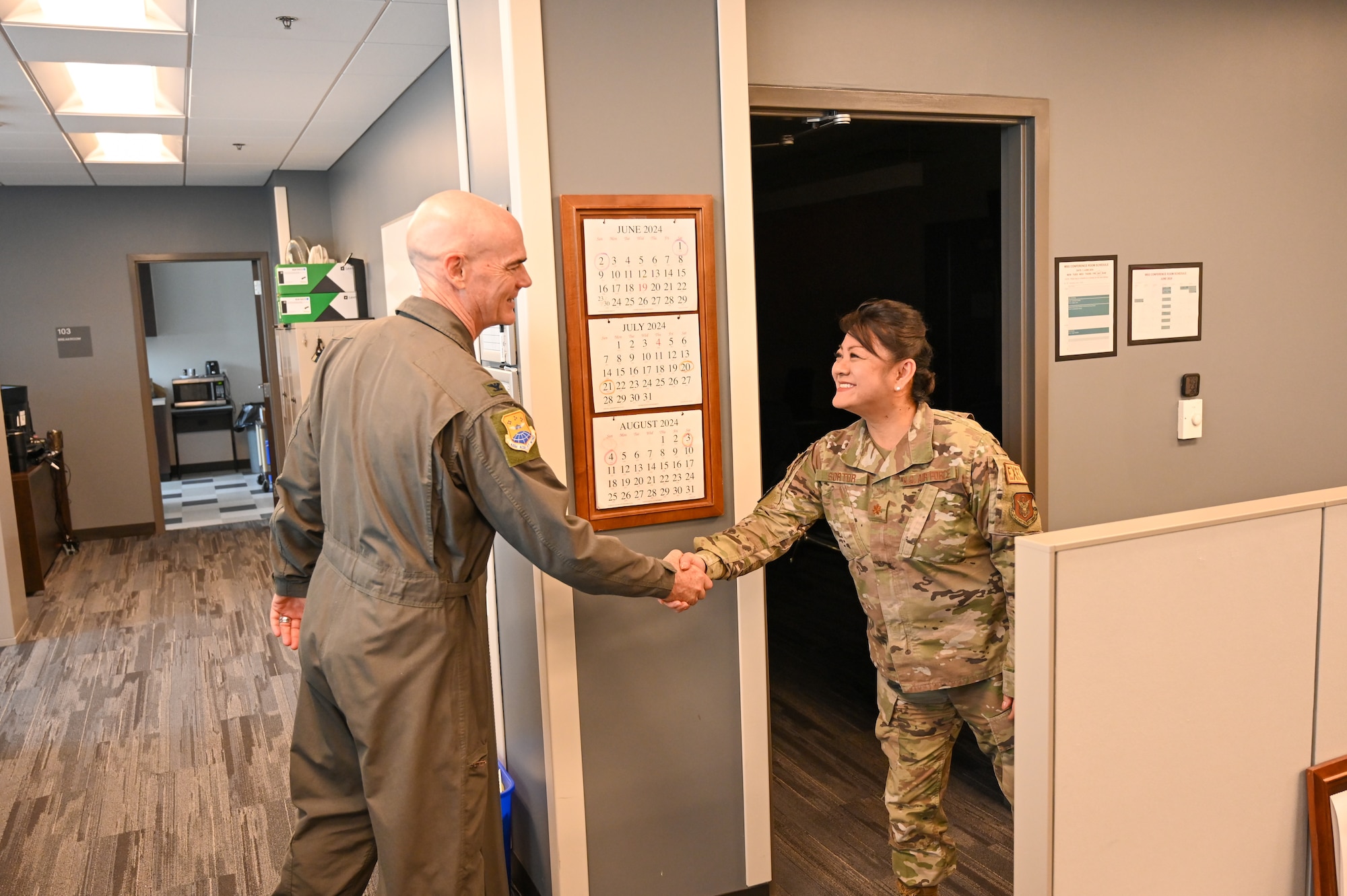 Col. William Gutermuth, 433rd Airlift Wing commander, shakes hands with Major Mika Sortor, 433rd Mission Support Group executive officer, during his tour to varying 433rd AW units to say farewell on his final Unit Training Assembly drill weekend here at Joint Base San Antonio-Lackland, Texas, June 6, 2024.