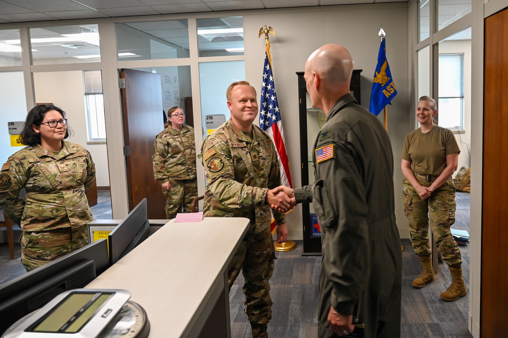 Col. William Gutermuth, 433rd Airlift Wing commander, shakes hands with leadership from the 433rd Medical Group leadership during a tour to varying 433rd AW units to say farewell on his final Unit Training Assembly drill weekend here at Joint Base San Antonio-Lackland, Texas, June 6, 2024.