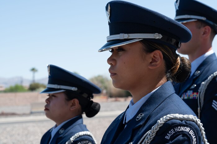 A woman in uniform stands at attention.