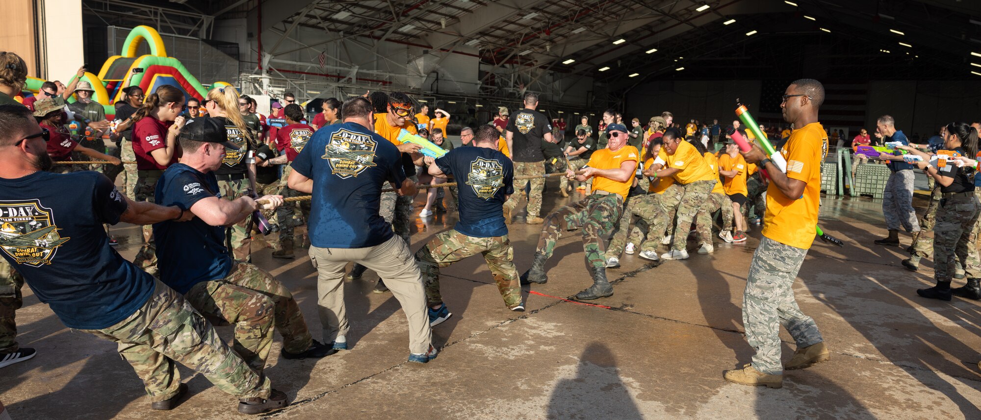 men and women playing Tug of war