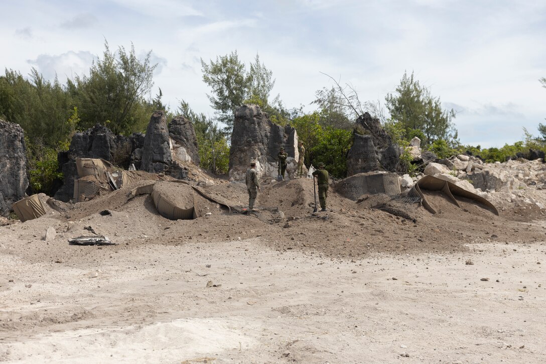U.S. Marine Corps, Australian Army, and Canadian Army service members overlook a detonation area of a demolition site during Operation Render Safe Nauru at Yaren, Nauru, May 30, 2024.