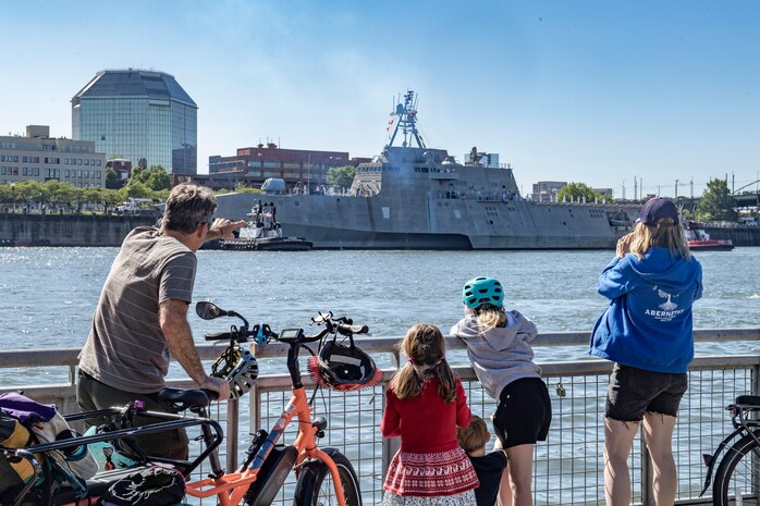 The Stoerts-Barrett family waves as the Independence-variant littoral combat ship USS Montgomery (LCS 8) arrives for the annual Rose Festival during Portland Fleet Week in Portland, Oregon, June 5, 2024. Portland Fleet Week is a time-honored celebration of the sea services and provides an opportunity for the citizens of Oregon to meet Sailors, Marines and Coast Guardsmen, as well as witness firsthand the latest capabilities of today’s maritime services. (U.S. Navy photo by Mass Communication Specialist 2nd Class Gwendelyn L. Ohrazda)