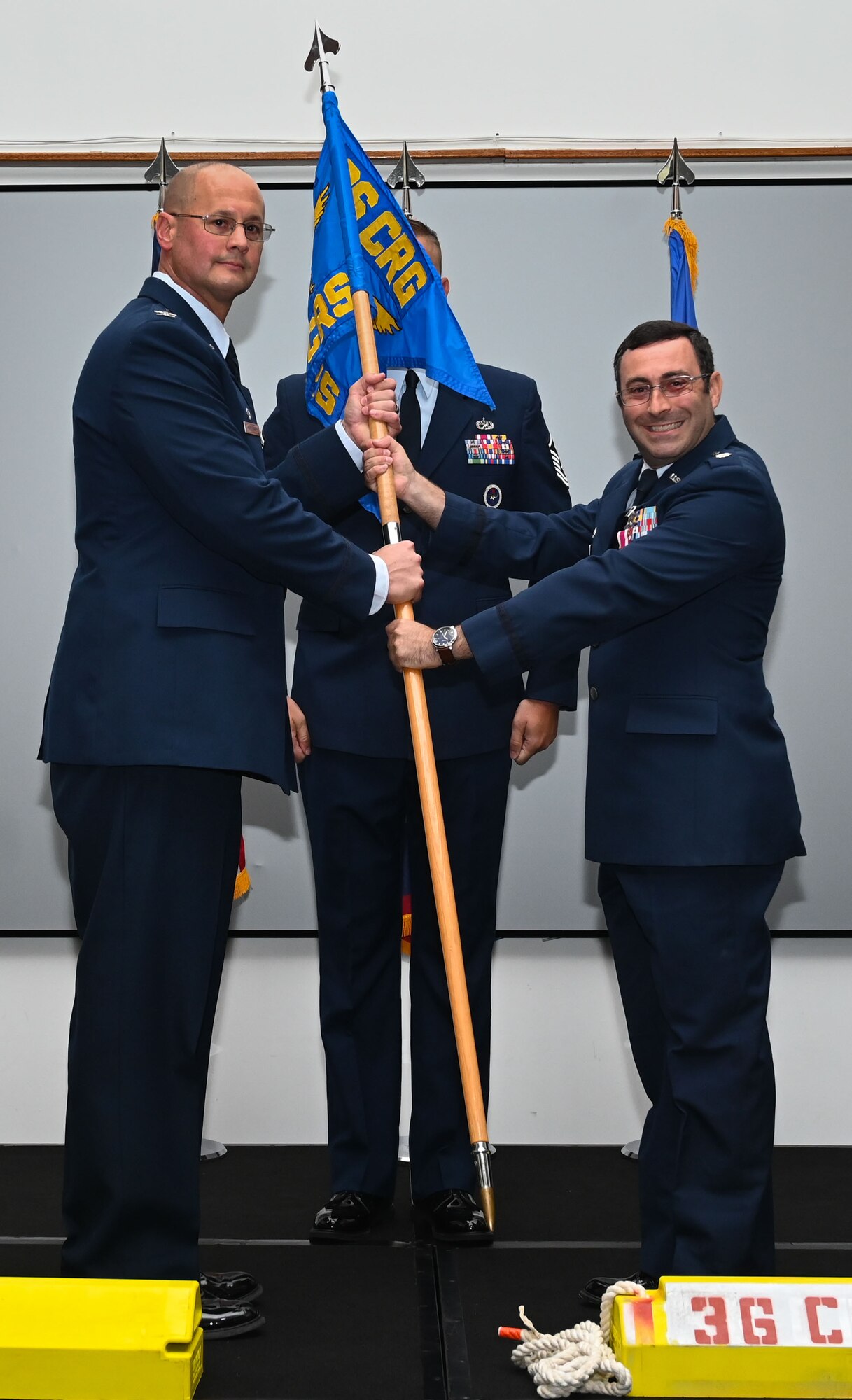 U.S. Air Force Col. Richard McElhaney, commander of the 36th Contingency Response Group, receives the guidon from outgoing commander of the 36th Contingency Response Squadron, Lt. Col. Stephen Smith, at Andersen Air Force Base, Guam, June 10, 2024. Smith relinquished command, provided remarks, and gave his final salute to the 36th CRS at the 36th CRS change of command ceremony. (U.S. Air Force photo by Airman 1st Class Natasha Ninete).
