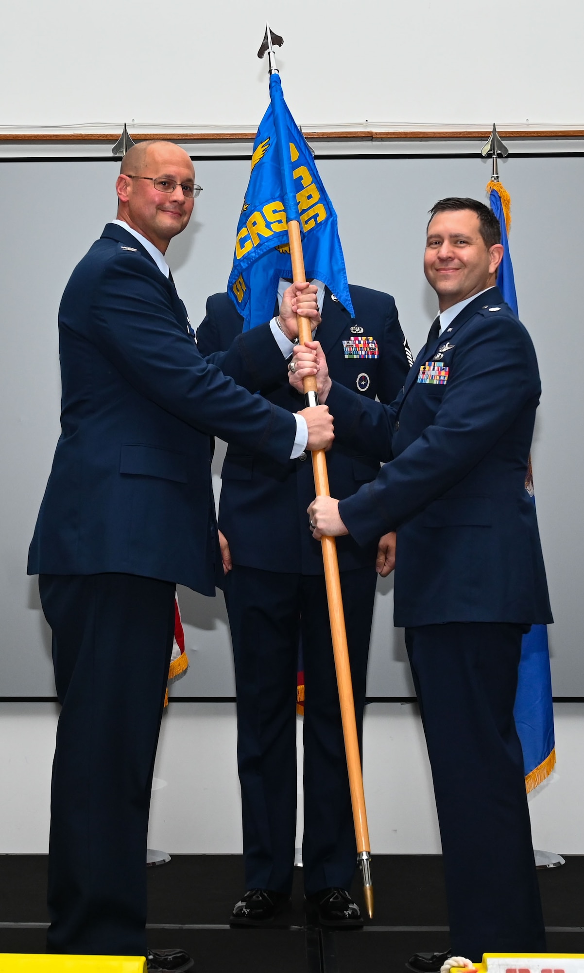 U.S. Air Force Col. Richard McElhaney, 36th Contingency Response Group commander, passes the guidon to the incoming commander of the 36th Contingency Response Squadron, Lt. Col. Jeffrey Schmidt, at Andersen Air Force Base, Guam, June 10, 2024. Prior to assuming command of the 36th CRS, Schmidt served as the wing Chief of Safety on Andersen AFB, Guam. (U.S. Air Force photo by Airman 1st Class Natasha Ninete).