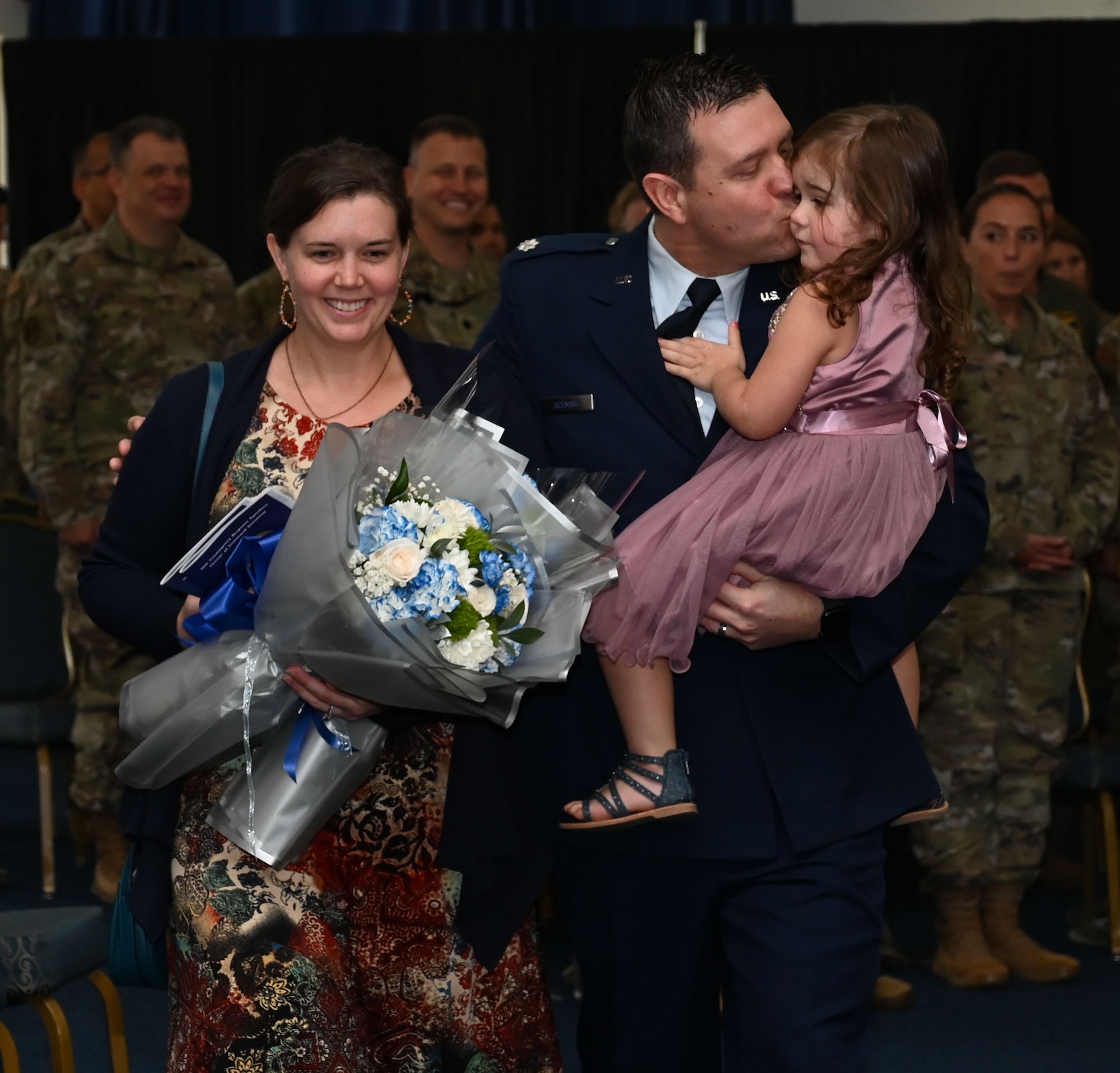 U.S. Air Force Lt. Col. Jeffrey Schmidt, 36th Contingency Response Squadron commander, and his family, depart from the 36th CRS change of command ceremony at Andersen Air Force Base, Guam, June 10, 2024. Schmidt honored his wife and daughter with a bouquet of flowers in celebration of his assumption of command and new journey in his career. (U.S. Air Force photo by Airman 1st Class Natasha Ninete).