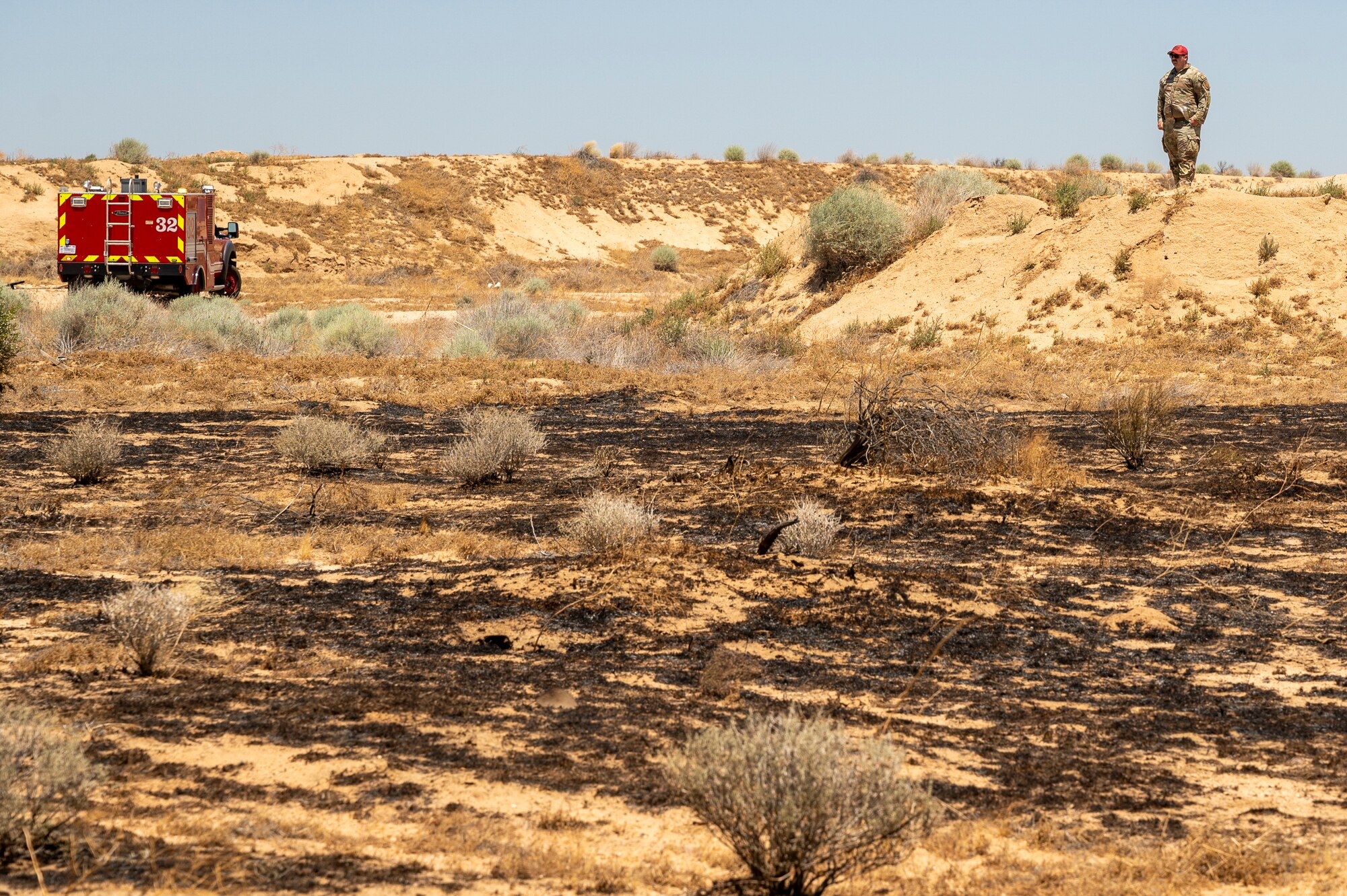 Firefighter crews from the 812th Civil Engineer Squadron Fire and Emergency Services respond to a brush fire near the Combat Arm Training and Maintenance facility on Edwards Air Force Base, California, June 7. The crews' quick reaction prevented the fire to spread to nearby structures and on-base housing. (Air Force photo by Lindsey Iniguez)