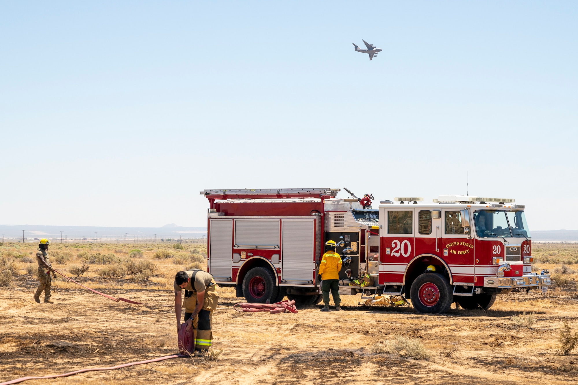 Firefighter crews from the 812th Civil Engineer Squadron Fire and Emergency Services respond to a brush fire near the Combat Arm Training and Maintenance facility on Edwards Air Force Base, California, June 7. The crews' quick reaction prevented the fire to spread to nearby structures and on-base housing. (Air Force photo by Laisa Leao)