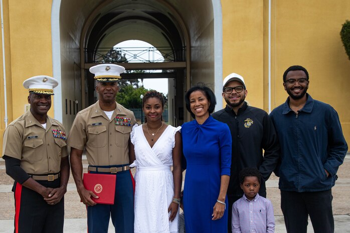 U.S. Marine Corps Brig. Gen. James A. Ryans, II, left, the commanding general of Marine Corps Recruit Depot San Diego and the Western Recruiting Region, and Col. Joseph W. Jones, second from left, the assistant chief of staff for the G-3 at MCRD San Diego, pose for a photo with friends and family following an award ceremony at MCRD San Diego, California, June 7, 2024. Jones was awarded the Legion of Merit medal, a United States Armed Forces award given for exceptionally meritorious conduct in the performance of outstanding services and achievements. Jones will be retiring in August after 30 years of service in the Marine Corps.(U.S. Marine Corps photo by Cpl. Elliott A. Flood-Johnson)