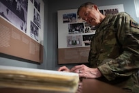 U.S. Army Maj. Gen. William Zana, director of international affairs with the National Guard Bureau, looks through a logbook of the guards of the Tomb of the Unknown Soldier in the Sentinel quarters at Arlington National Cemetery May 31, 2024.