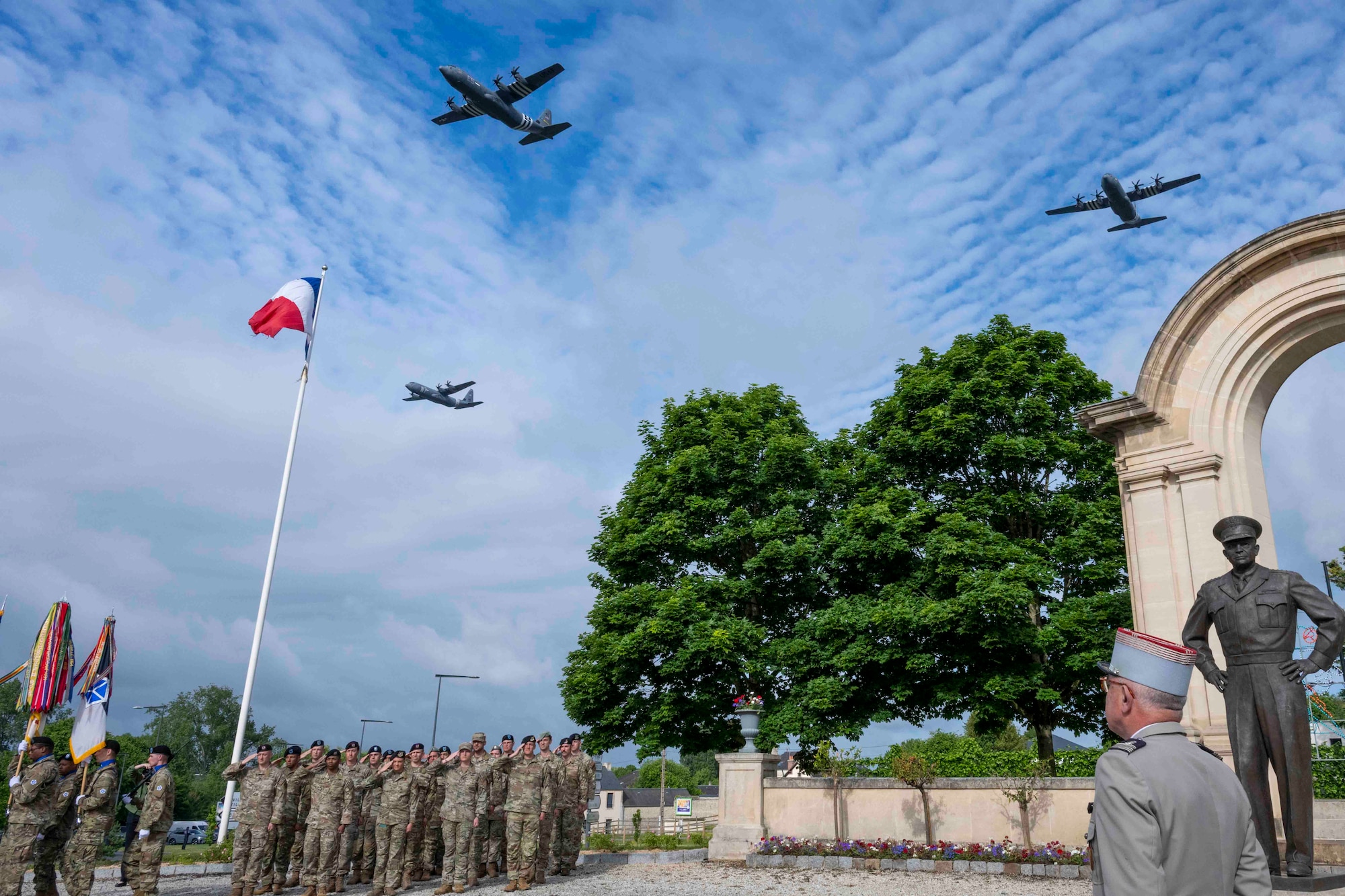 Three U.S. Air Force C-130J Super Hercules fly over the D-Day Allied Ceremony honoring Dwight Eisenhower, June 5, 2024, at Bayeux, France. Overall, World War II remains an enduring historic reminder of how Allies sharing a common purpose and vision forge proven partnerships and reinforce bonds that remain to this day. (U.S. Air Force photo by Senior Airman Jessica Sanchez-Chen)