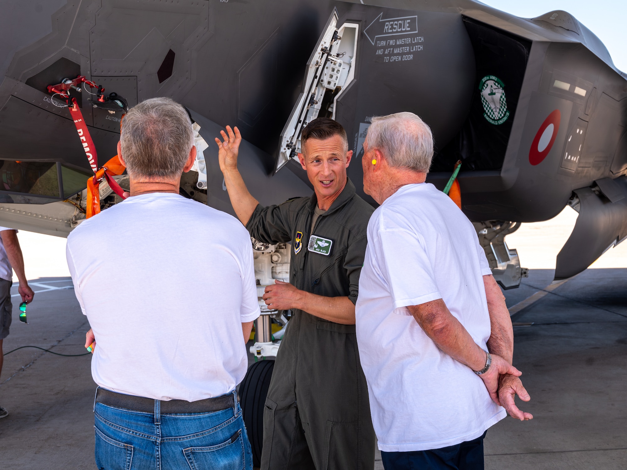 U.S. Air Force Lt. Col. Brett Black (center), 308th Fighter Squadron commander, shows an F-35A Lightning II to retired Lt. Col. David Kling (right) and retired Lt. Gen. Burton Field (left) during a heritage tour, March. 31, 2024 at Luke Air Force Base, Arizona.