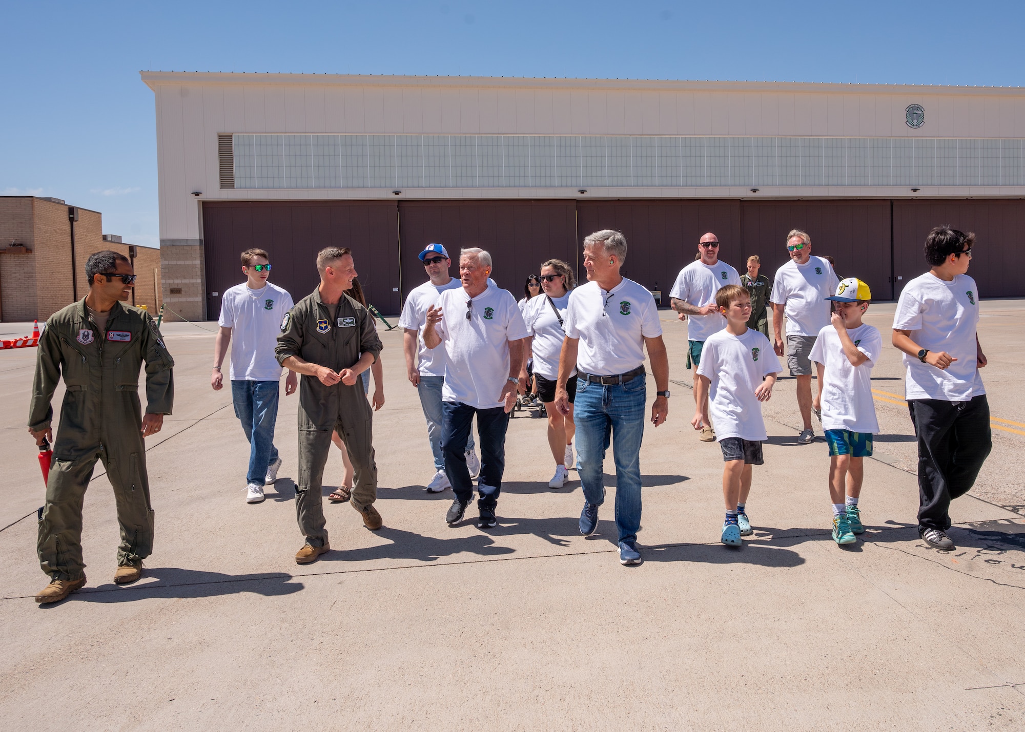 Retired U.S. Air Force Lt. Col. David Kling (center left), speaks with Lt. Col. Brett Black (left), 308th Fighter Squadron commander, on the flight line during a heritage tour, March. 31, 2024 at Luke Air Force Base, Arizona.