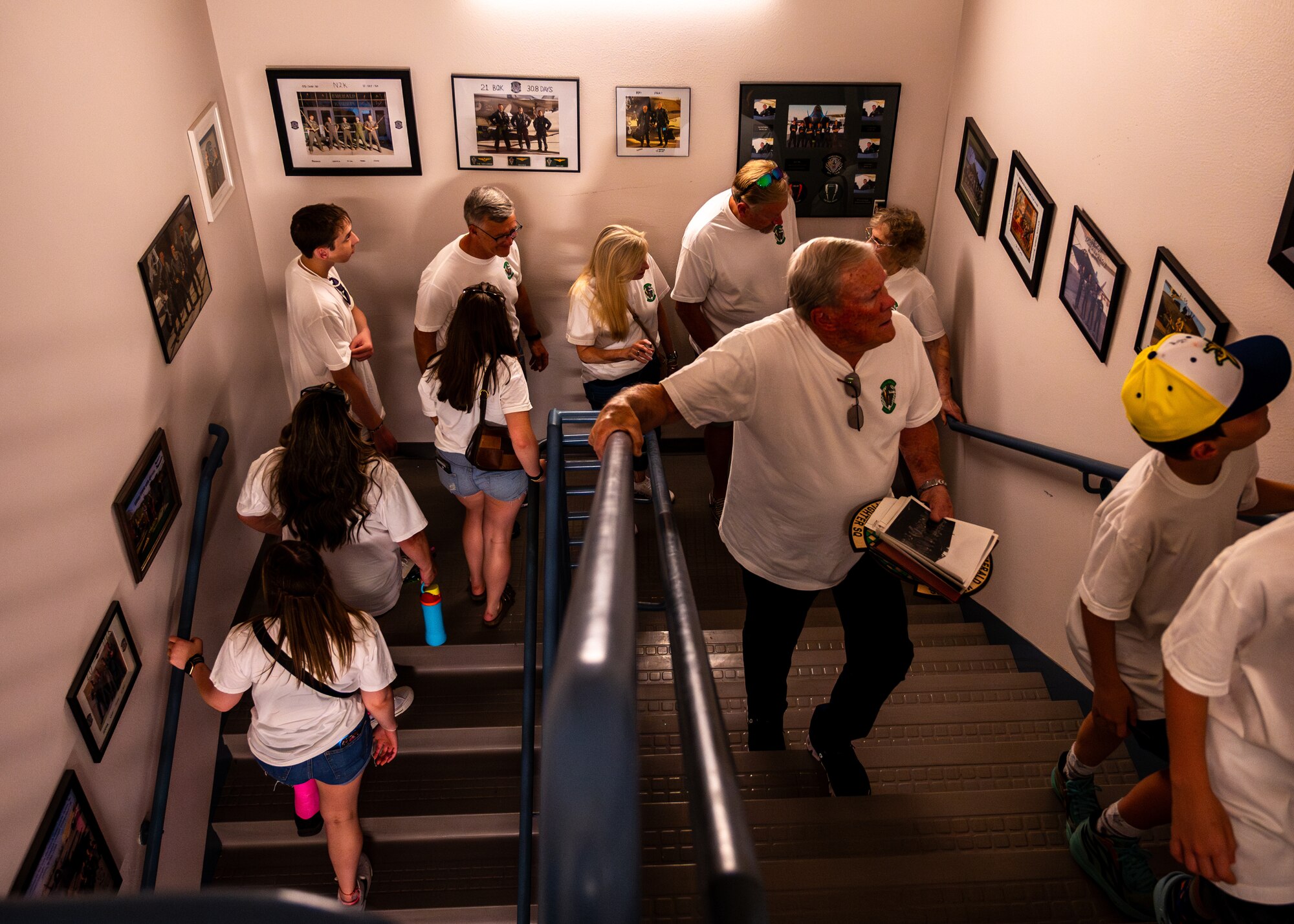 Retired U.S. Air Force Lt. Col. David Kling (center right), views historical photos of the 308th Fighter Squadron with his family during a heritage tour, March. 31, 2024 at Luke Air Force Base, Arizona.