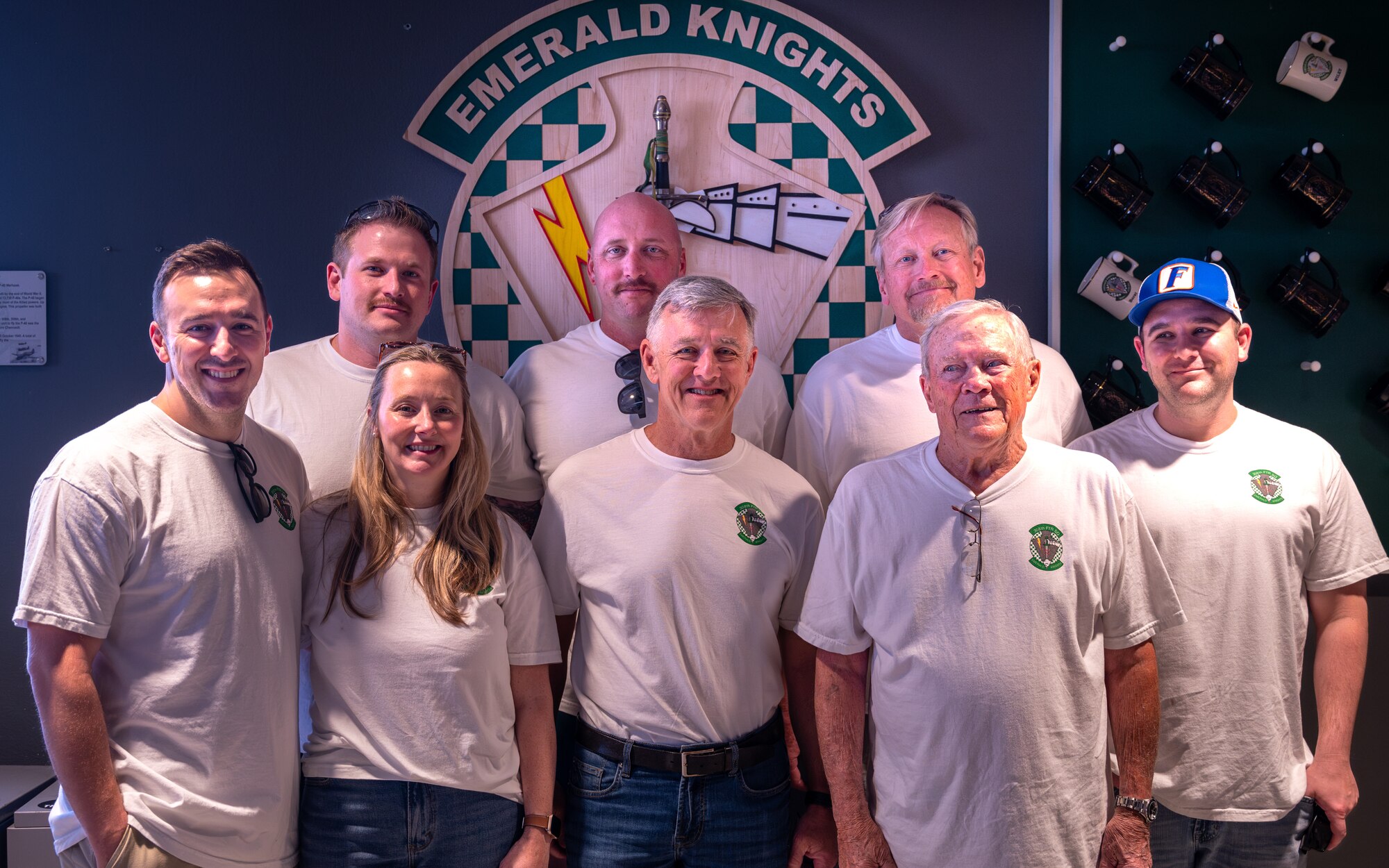 Retired U.S. Air Force Lt. Col. David Kling (center right), poses in front of a 308th Fighter Squadron plaque with the seven service members in his family during a heritage tour, March. 31, 2024 at Luke Air Force Base, Arizona.