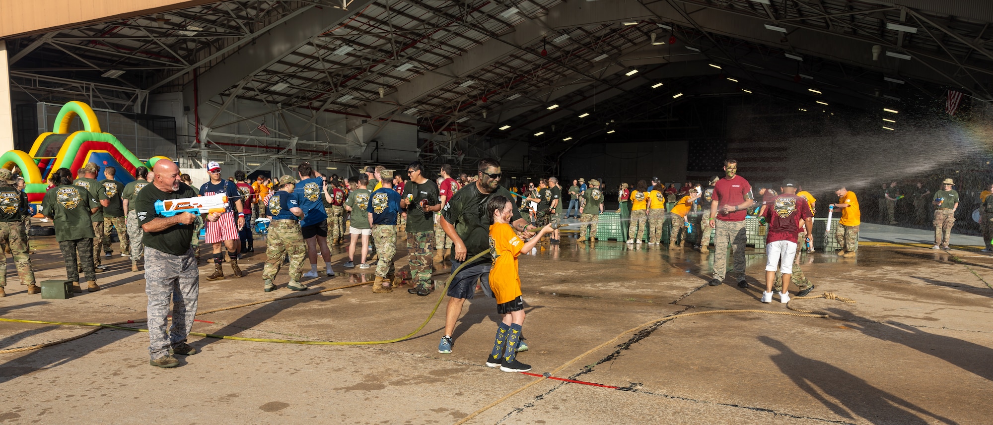 men, women and boy shooting water guns