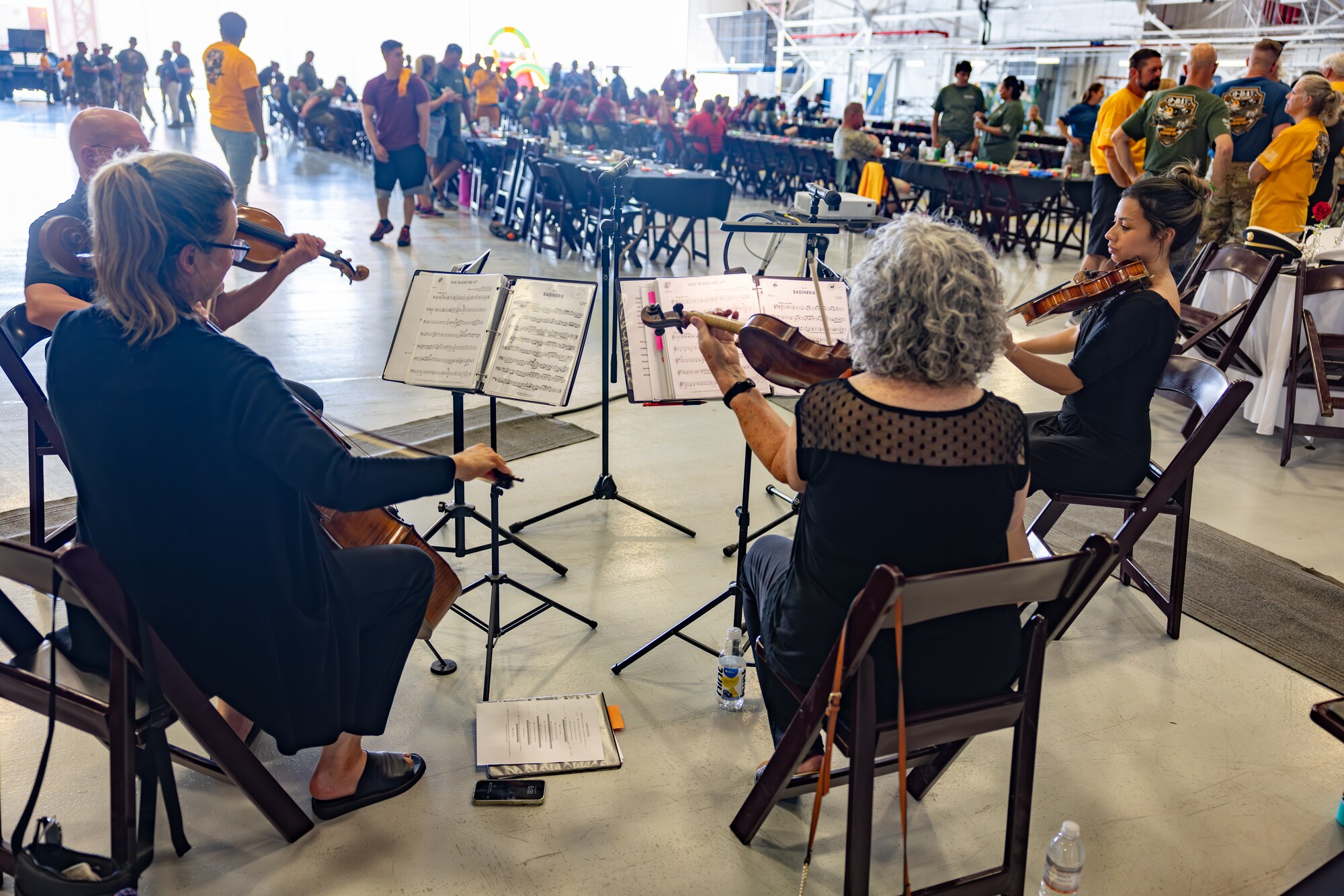 Men and women playing violins