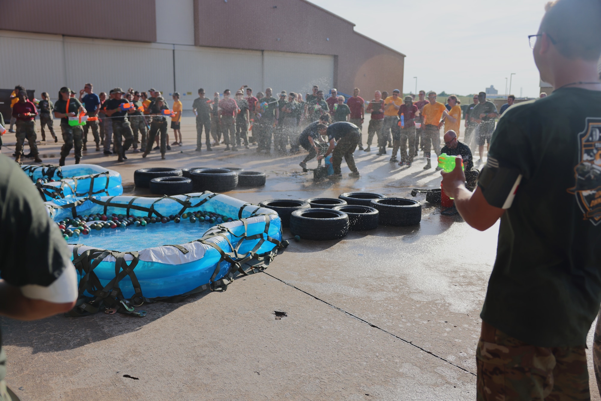 men and women playing with water guns