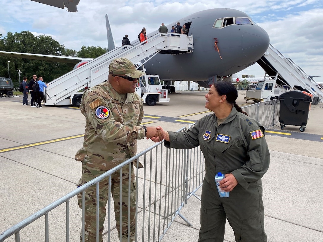 U.S. Air Force Maj. Gen. Dana Nelson, mobilization assistant to the deputy commander of United States Air Forces in Europe – Air Force Africa, shakes hands with Master Sgt. Jerome Saunders, a member of the Air Force Installation and Mission Support Center, Detachment 4, near a U.S. Air Force KC-46 Pegasus aircraft at the Berlin Innovation & Leadership in Aerospace trade show and air show, June 5, 2024, in Berlin, Germany. The U.S. Air Force, Army and Navy had aircraft on display at the show to support the longstanding partnership with Germany. (U.S. Air Force photo by Senior Master Sgt. Dan Heaton)