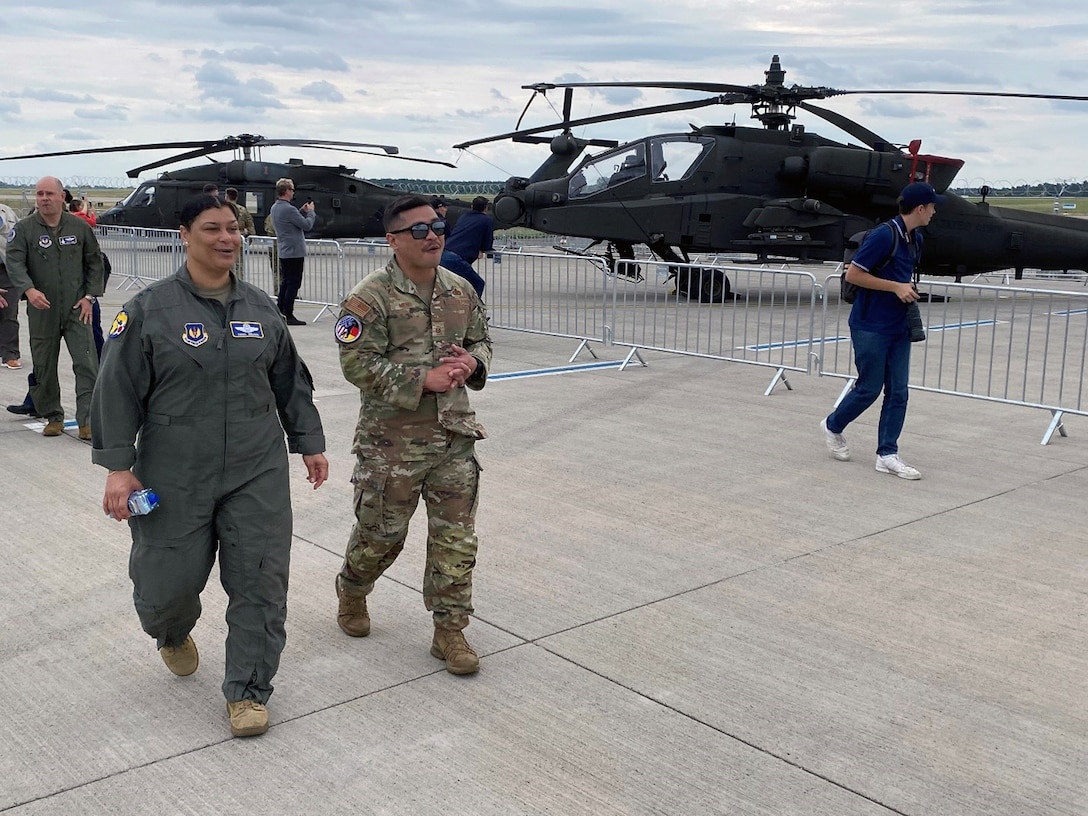 U.S. Air Force Maj. Gen. Dana Nelson, mobilization assistant to the deputy commander of United States Air Forces in Europe – Air Force Africa, walks past a display of U.S. Army helicopters with USAF Master Sgt. Alan Meno, a member of the Air Force Installation and Mission Support Center, Detachment 4, at the Berlin Innovation & Leadership in Aerospace trade show and air show, June 5, 2024, in Berlin, Germany. The U.S. Air Force, Army and Navy had aircraft on display at the show to support the USA’s longstanding partnership with Germany. (U.S. Air Force photo by Senior Master Sgt. Dan Heaton)