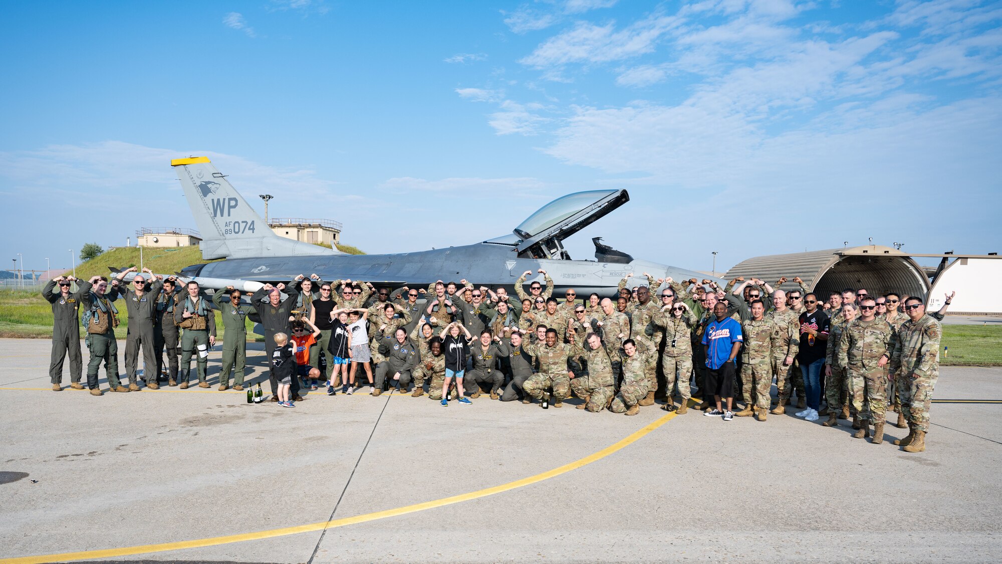 Friends and family of U.S. Air Force Col. Matthew Gaetke, 8th Fighter Wing commander, pose for a group photo after his final flight at Kunsan Air Base, Republic of Korea.