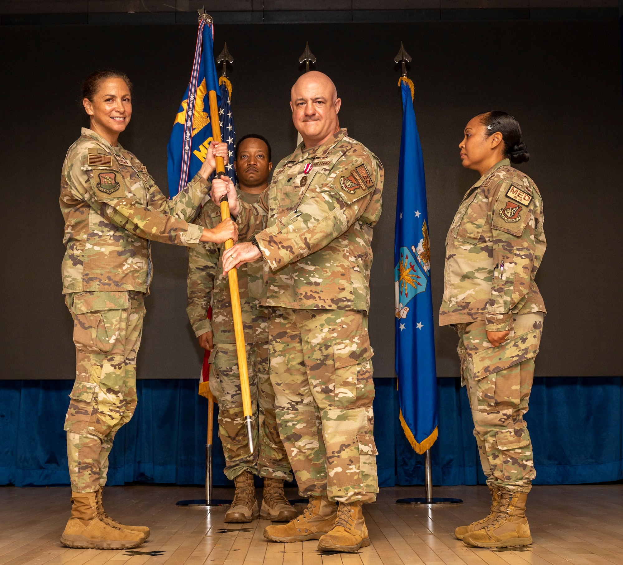 U.S. Air Force Lt. Col. Marc Rittberg, middle, relinquishes command of the 51st Medical Support Squadron to Col. Mocha Robinson, left, 51st Medical Group commander, during a change of command ceremony at Osan Air Base, Republic of Korea, June 11, 2024. Rittberg commissioned in 2004 as a Medical Service Corps officer and has held various medical positions throughout his career. (U.S Air Force photo by Senior Airman Sabrina Fuller-Judd)