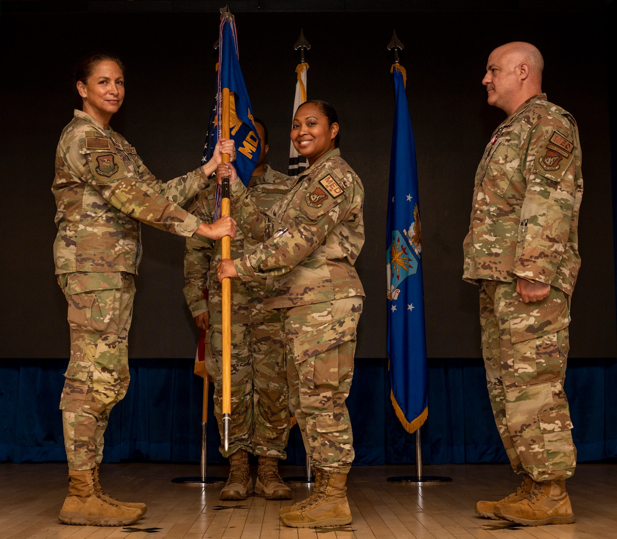 U.S. Air Force Lt. Col. Joy Spillers, middle, accepts command of the 51st Medical Support Squadron from Col. Mocha Robinson, left, 51st Medical Group commander, during a change of command ceremony at Osan Air Base, Republic of Korea, June 11, 2024. Before taking command, Spillers served as the 39th Healthcare Operations Squadron commander, Incirlik Air Base, Turkey. (U.S Air Force photo by Senior Airman Sabrina Fuller-Judd)