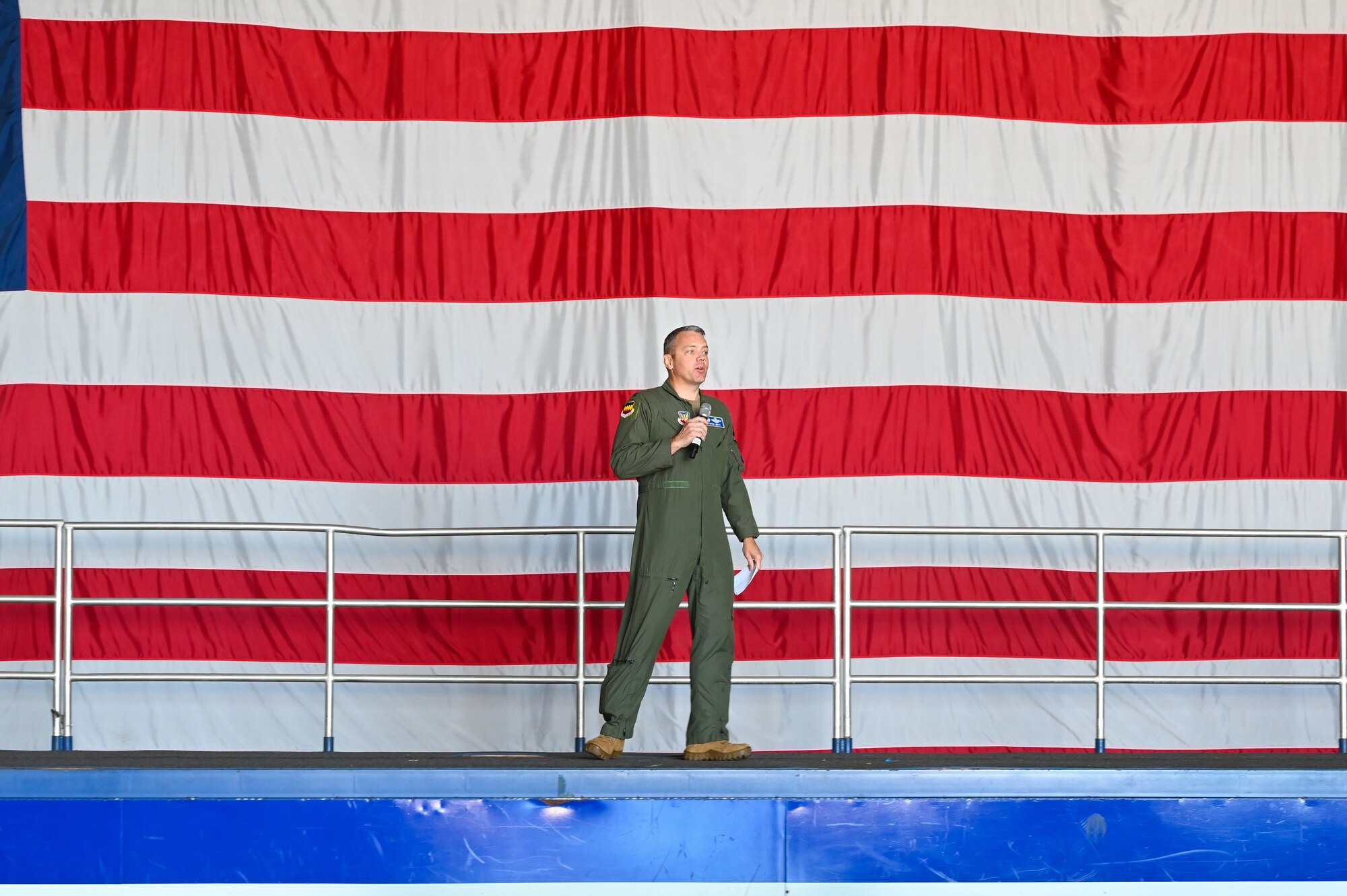 Military commander gives a speech with the American flag as the background.