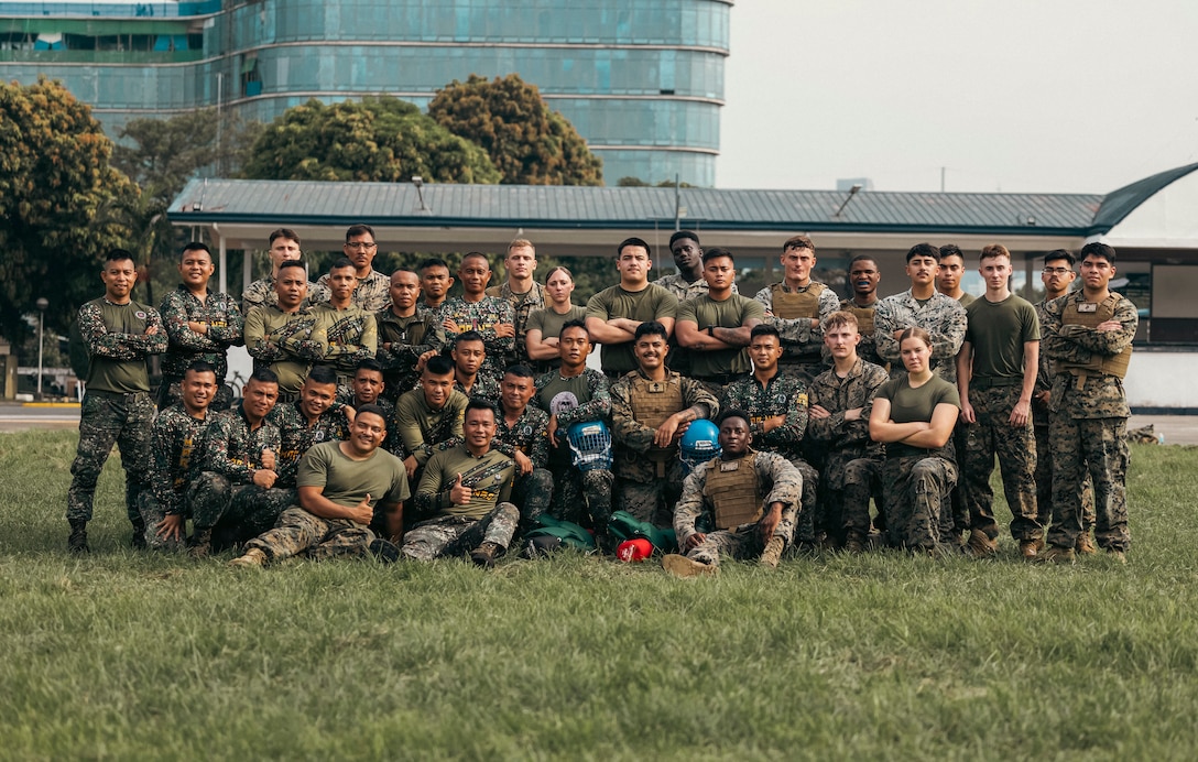 U.S. Marines with I Marine Expeditionary Force (Forward); Marine Aircraft Group 13, 3rd Marine Aircraft Wing, and Philippine Marines pose for a photo after pugil stick bouts during a Marine Corps Martial Arts Program demonstration for Marine Aviation Support Activity 24 on Fort Bonifacio, Manila, Philippines, June 10, 2024. MCMAP training combines hand-to-hand and close-quarters combat techniques with warrior ethos studies and physical training. MASA is an annual Philippine-U.S. military exercise focused on mutual defense, strengthening relationships, and rehearsing emerging aviation concepts. (U.S. Marine Corps photo by Sgt. Shaina Jupiter)