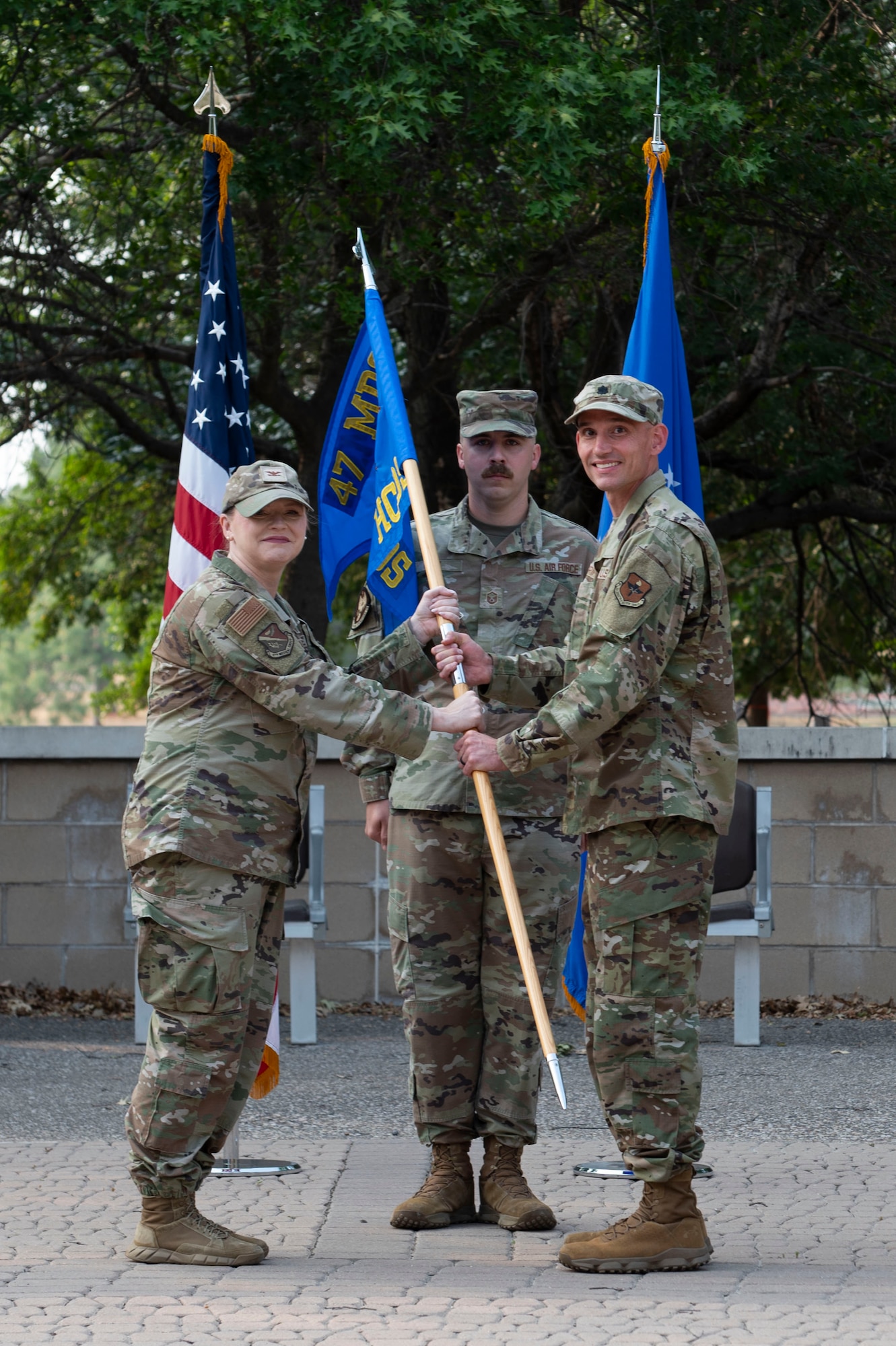 U.S. Air Force Lt. Col. Daniel Griffith accepts the 47th Healthcare Operations Squadron guidon from Col. Angela Lacek, 47th Medical Group commander, during the 47th HCOS change of command ceremony at Laughlin Air Force Base, Texas, June 7, 2024. The passing of the guidon to Griffith signifies his acceptance of command of the 47th HCOS. (U.S. Air Force photo by Senior Airman Kailee Reynolds)