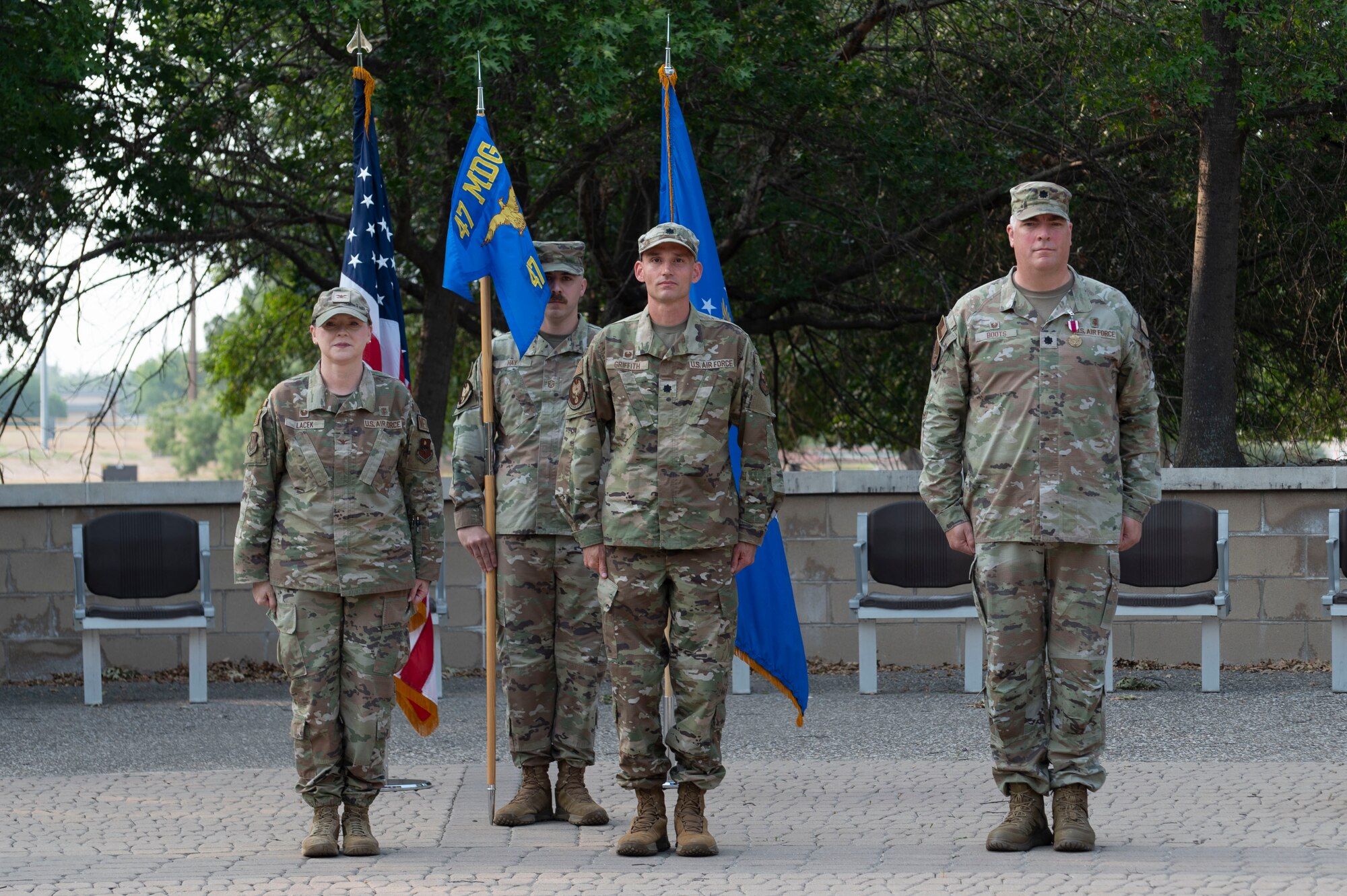 (From left to right) U.S. Air Force Col. Angela Lacek, 47th Medical Group commander, Lt. Col. Daniel Griffith, current 47th Healthcare Operations Squadron (HCOS) commander, and Lt. Col. Neil Boots, former 47th HCOS commander, stand at attention during the 47th HCOS change of command ceremony at Laughlin Air Force Base, Texas, June 7, 2024. Change of command ceremonies represent a formal transfer of authority and responsibility for a unit from one commanding officer to another. (U.S. Air Force photo by Senior Airman Kailee Reynolds)